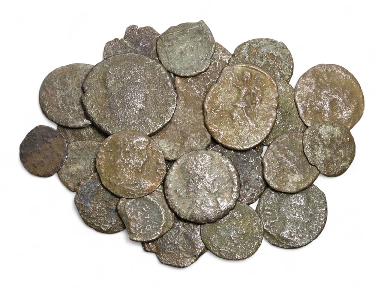 Ancient Roman Bronze Coins Lot, AE3 and AE4, c. 3rd-5th Century CE, 25 Coins: This lot of 25 bronze coins represents the currency of the late Roman Empire, spanning the 3rd to 5th centuries CE. These pieces, known as AE3 and AE4 denominations, were the small change of the Roman