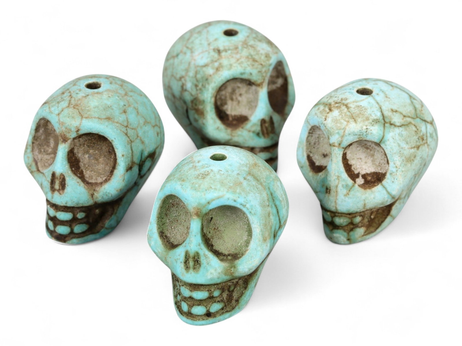 Vintage Tibetan Turquoise Skull Beads, Set of Four, c. Mid-20th Century, 2cm: This striking set of four turquoise-carved skull beads, originates from Tibet and dates to the mid-20th century. Finely shaped and perforated for stringing, each bead represents a human skull, a motif
