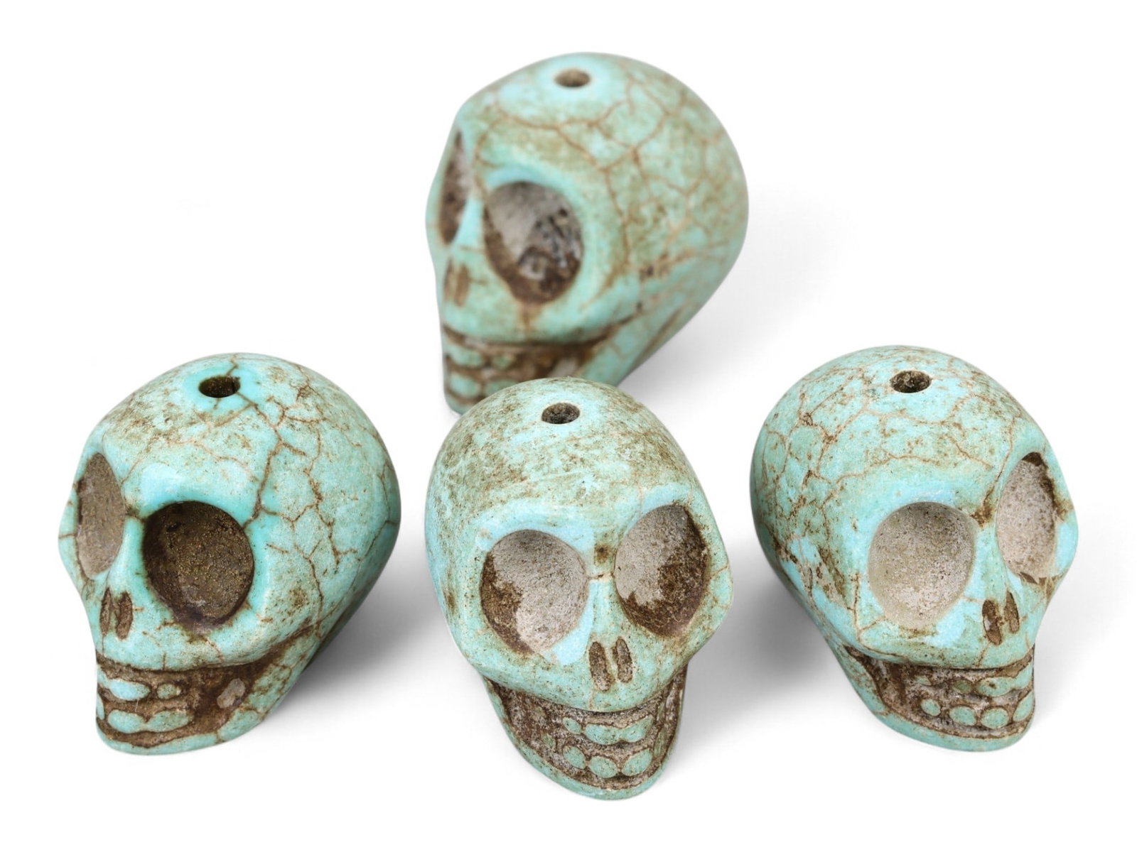 Vintage Tibetan Turquoise Skull Beads, Set of Four, c. Mid-20th Century, 2cm: This striking set of four turquoise-carved skull beads, originates from Tibet and dates to the mid-20th century. Finely shaped and perforated for stringing, each bead represents a human skull, a motif