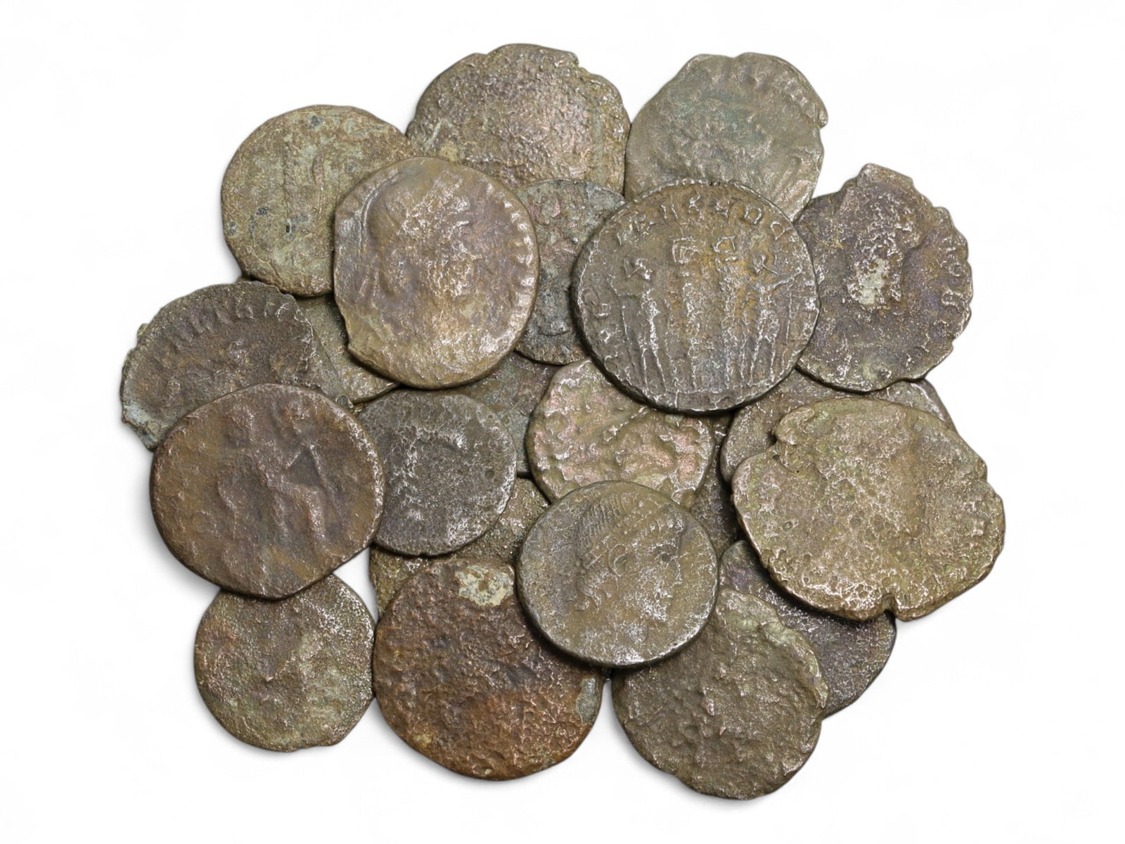 Ancient Roman Bronze Coins Lot, AE3 and AE4, c. 3rd-5th Century CE, 25 Coins: This lot of 25 bronze coins represents the currency of the late Roman Empire, spanning the 3rd to 5th centuries CE. These pieces, known as AE3 and AE4 denominations, were the small change of the Roman