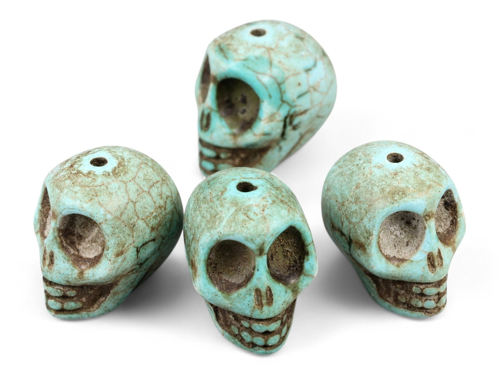 Vintage Tibetan Turquoise Skull Beads, Set of Four, c. Mid-20th Century, 2cm: This striking set of four turquoise-carved skull beads, originates from Tibet and dates to the mid-20th century. Finely shaped and perforated for stringing, each bead represents a human skull, a motif