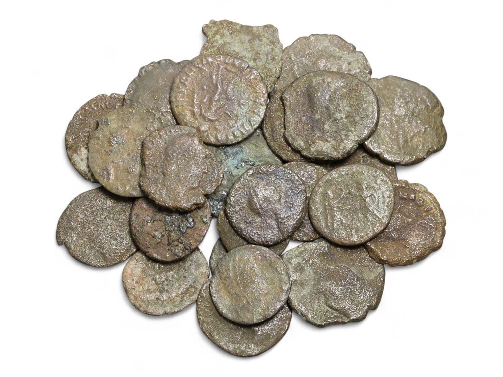 Ancient Roman Bronze Coins Lot, AE3 and AE4, c. 3rd-5th Century CE, 25 Coins: This lot of 25 bronze coins represents the currency of the late Roman Empire, spanning the 3rd to 5th centuries CE. These pieces, known as AE3 and AE4 denominations, were the small change of the Roman