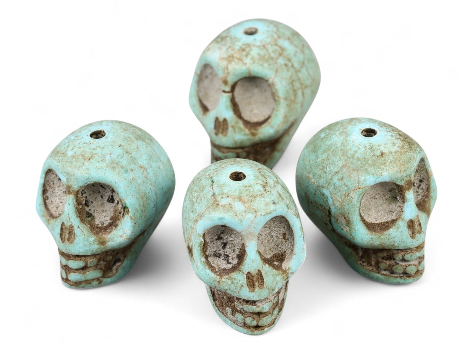Vintage Tibetan Turquoise Skull Beads, Set of Four, c. Mid-20th Century, 2cm: This striking set of four turquoise-carved skull beads, originates from Tibet and dates to the mid-20th century. Finely shaped and perforated for stringing, each bead represents a human skull, a motif