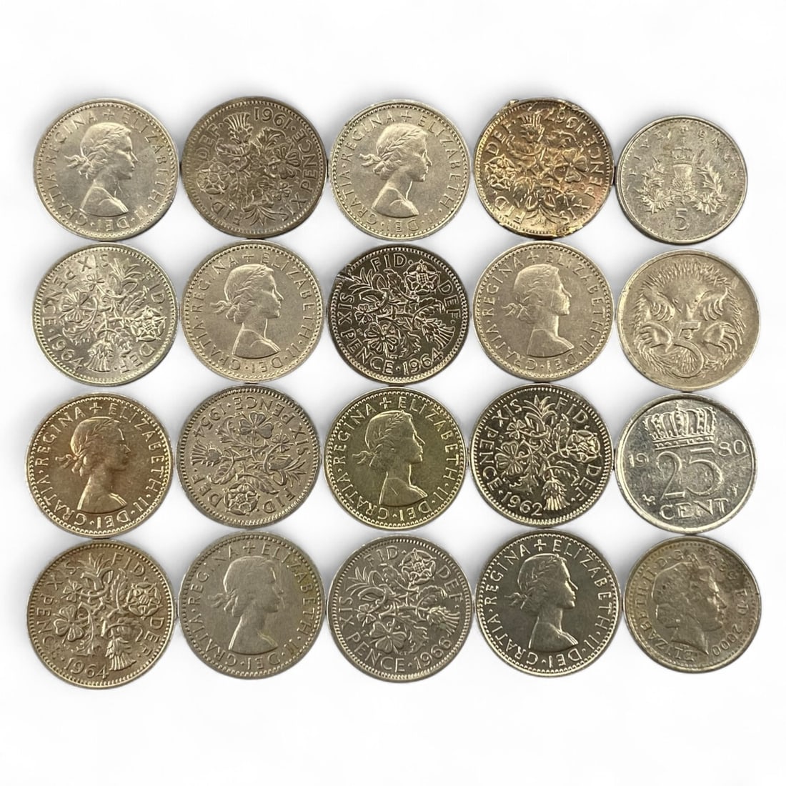 UNITED KINGDOM & COMMONWEALTH: Elizabeth II - Floral Harmony Lot of 20 Coins (1950s-1980s): A radiant ensemble celebrating the early reign of Queen Elizabeth II, this twenty-coin lot captures the refined artistry and symbolism of mid-century British and Commonwealth minting. Predominantly co