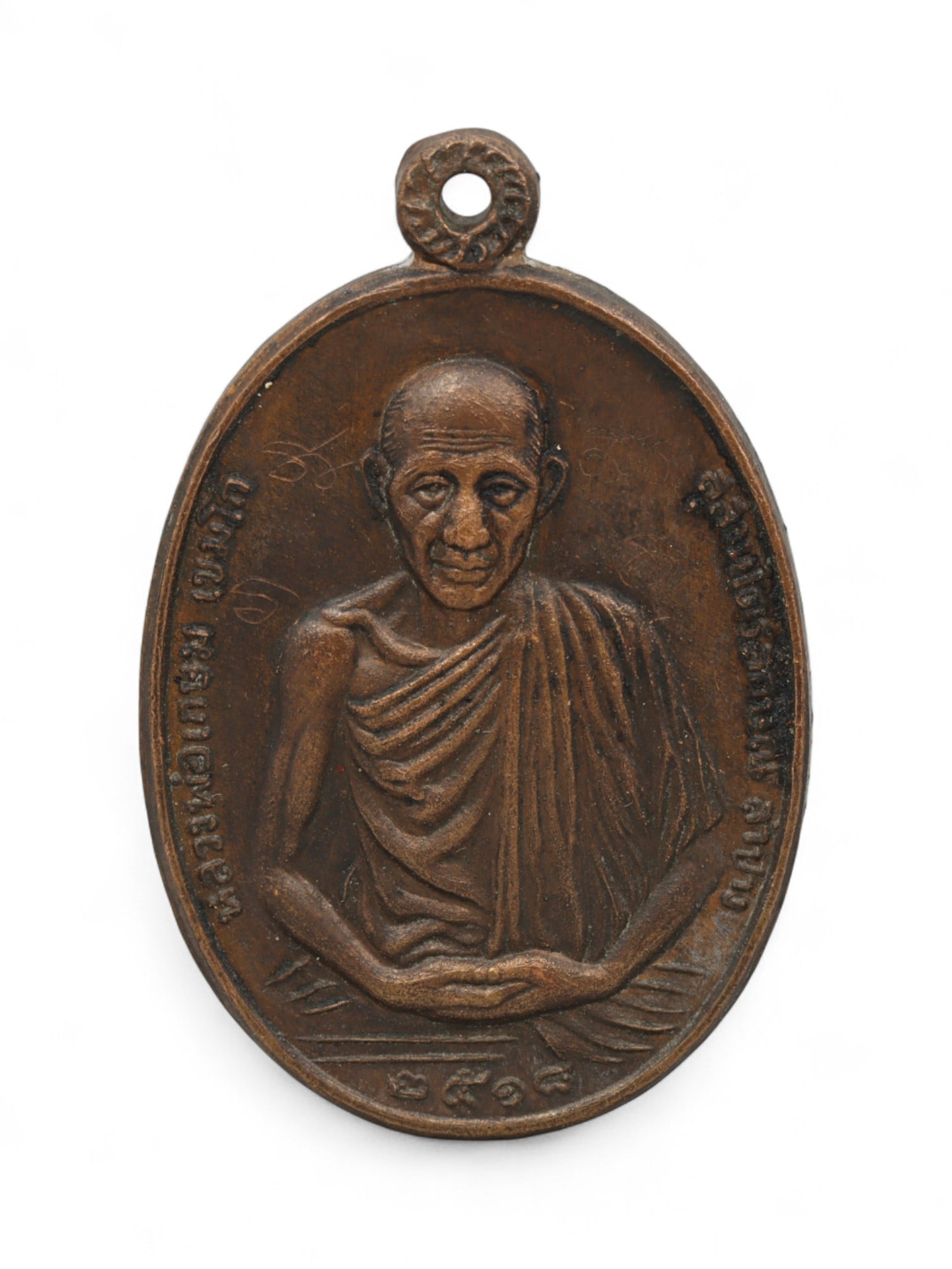 Vintage Thai Buddhist Bronze Monk Amulet, c. Mid-20th Century CE, 4cm: This vintage Thai bronze amulet, crafted in the mid-20th century, depicts a revered Buddhist monk in serene meditation. Such medallions, known as phra kruang or monk amulets, are highly cherished in T