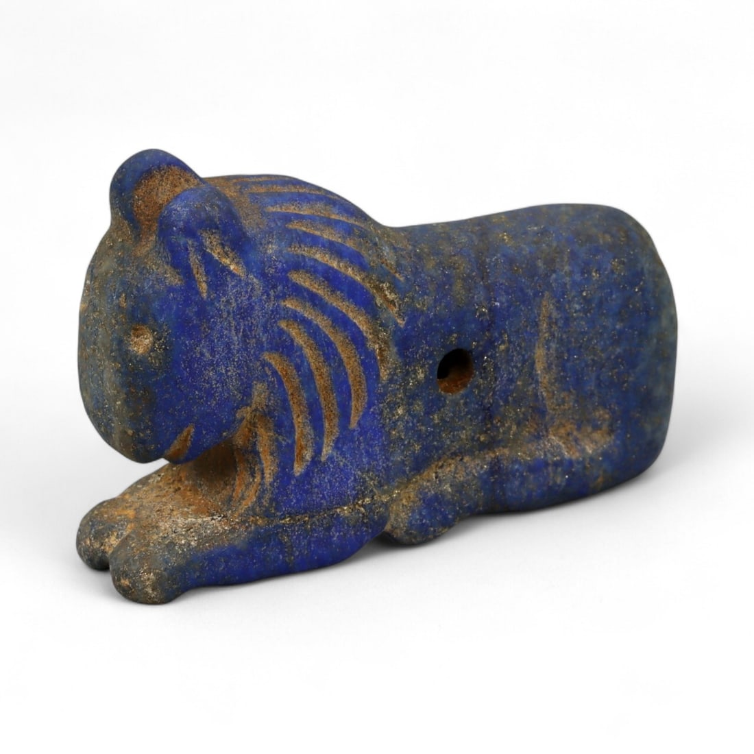 Ancient Bactrian Lapis Lazuli Lion Effigy, c. 2nd-1st Millennium BCE, 5cm: This striking lapis lazuli effigy, carved in the form of a recumbent lion, originates from ancient Bactria, circa 2nd-1st millennium BCE. Sculpted from vibrant blue lapis lazuli streaked with veins of