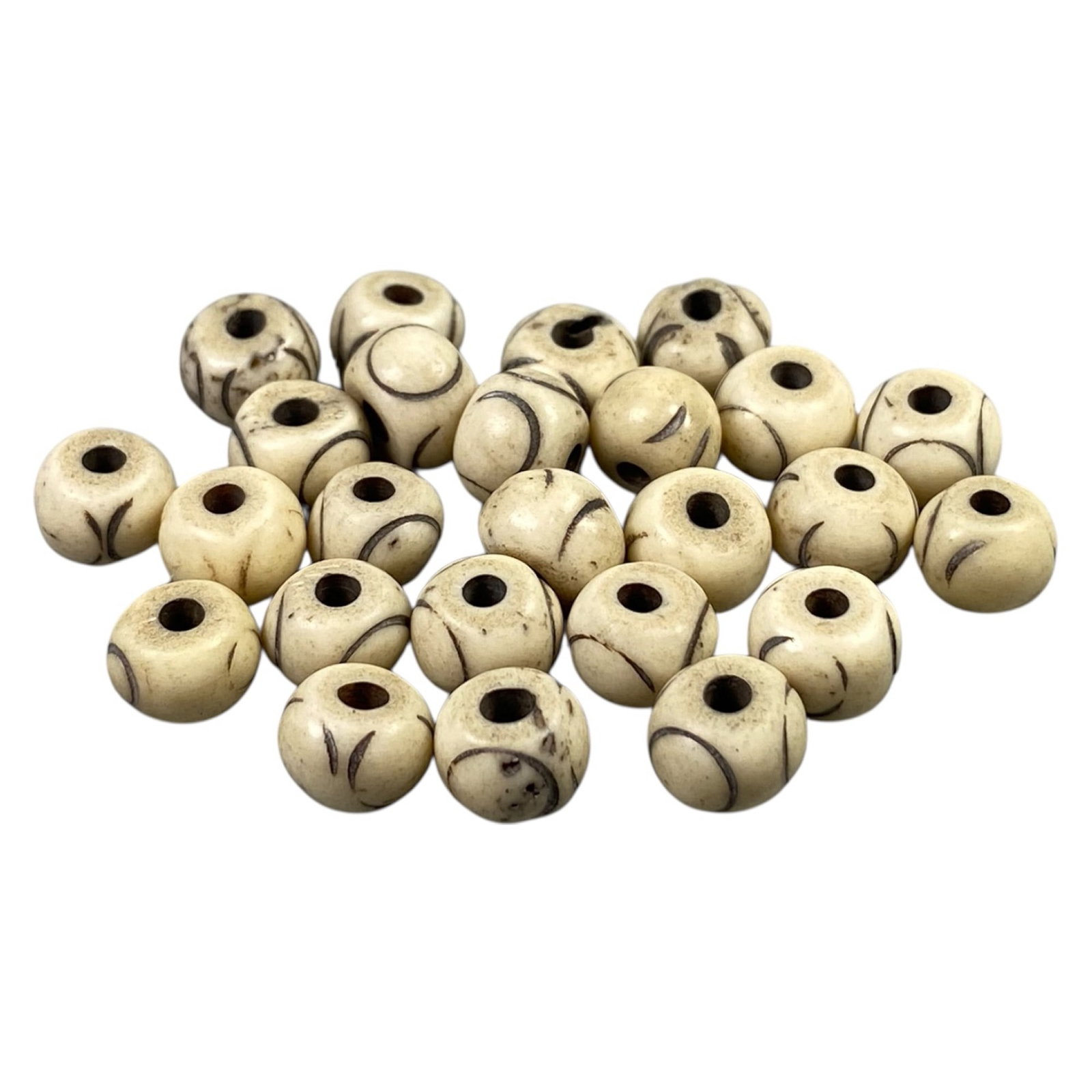 Vintage Tibetan Hand-Carved Bone Beads, c. 20th Century, 1cm: This collection of vintage Tibetan bone beads embodies the spiritual artistry of Himalayan craftsmanship from the 20th century. Handmade by local artisans, each bead carries the organic warmth of natu
