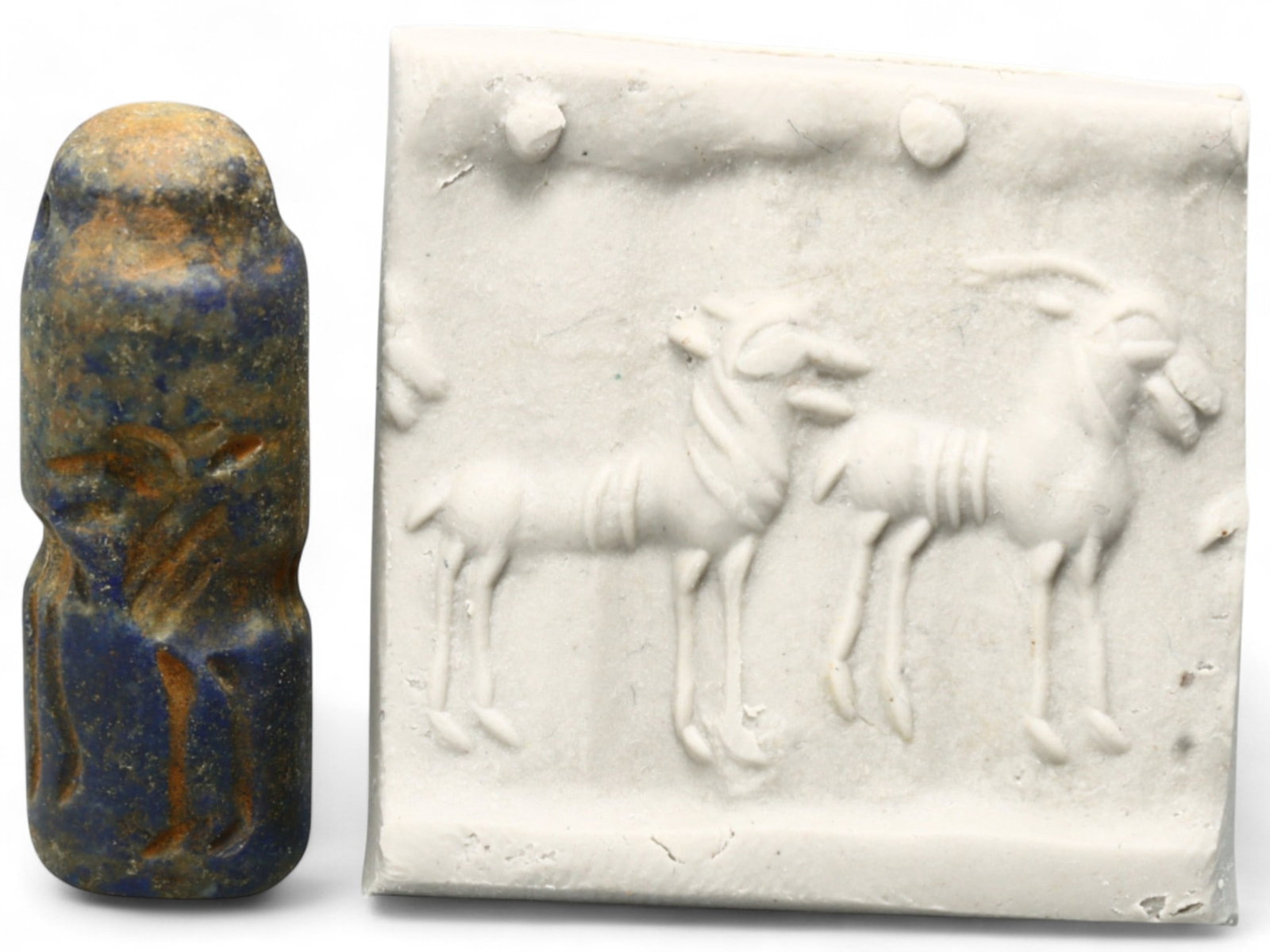 Ancient Akkadian Triple Ibex Celestial Lapis Lazuli Cylinder Seal, c. 2350-2150 BCE, 6g: This striking cylinder seal, carved from richly hued lapis lazuli, is a masterful example of Akkadian artistry from c. 2350-2150 BCE. The seal features three regal ibex-like creatures, each depicted i