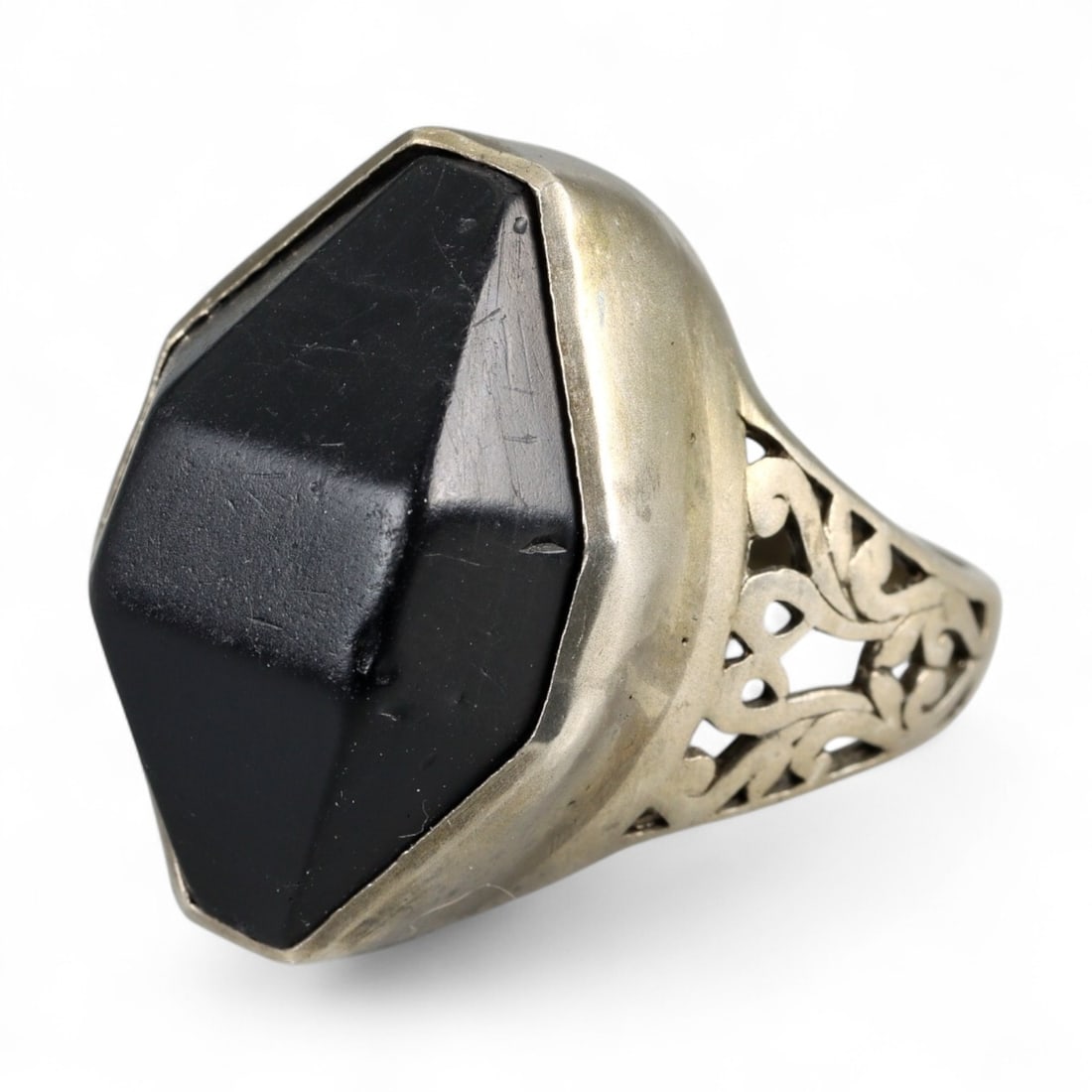 Antique Persian Black Onyx Faceted Silver Ring, c. 19th Century 11g: This imposing antique silver ring from 19th century Persia reflects the bold artistry of the Qajar dynasty, when jewelry often balanced ornament with protective symbolism. The centerpiece is a large, 