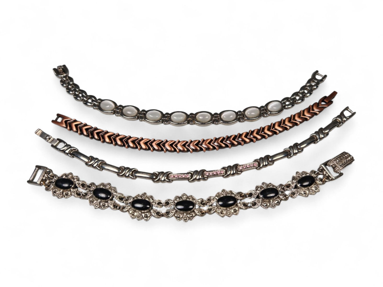 Set of Four Vintage Link Bracelets - Mixed Metal and Gemstone Designs: This refined set of four vintage bracelets showcases a diverse range of styles and materials, each offering its own unique aesthetic appeal. Measuring approximately 7 cm each, the collection combines
