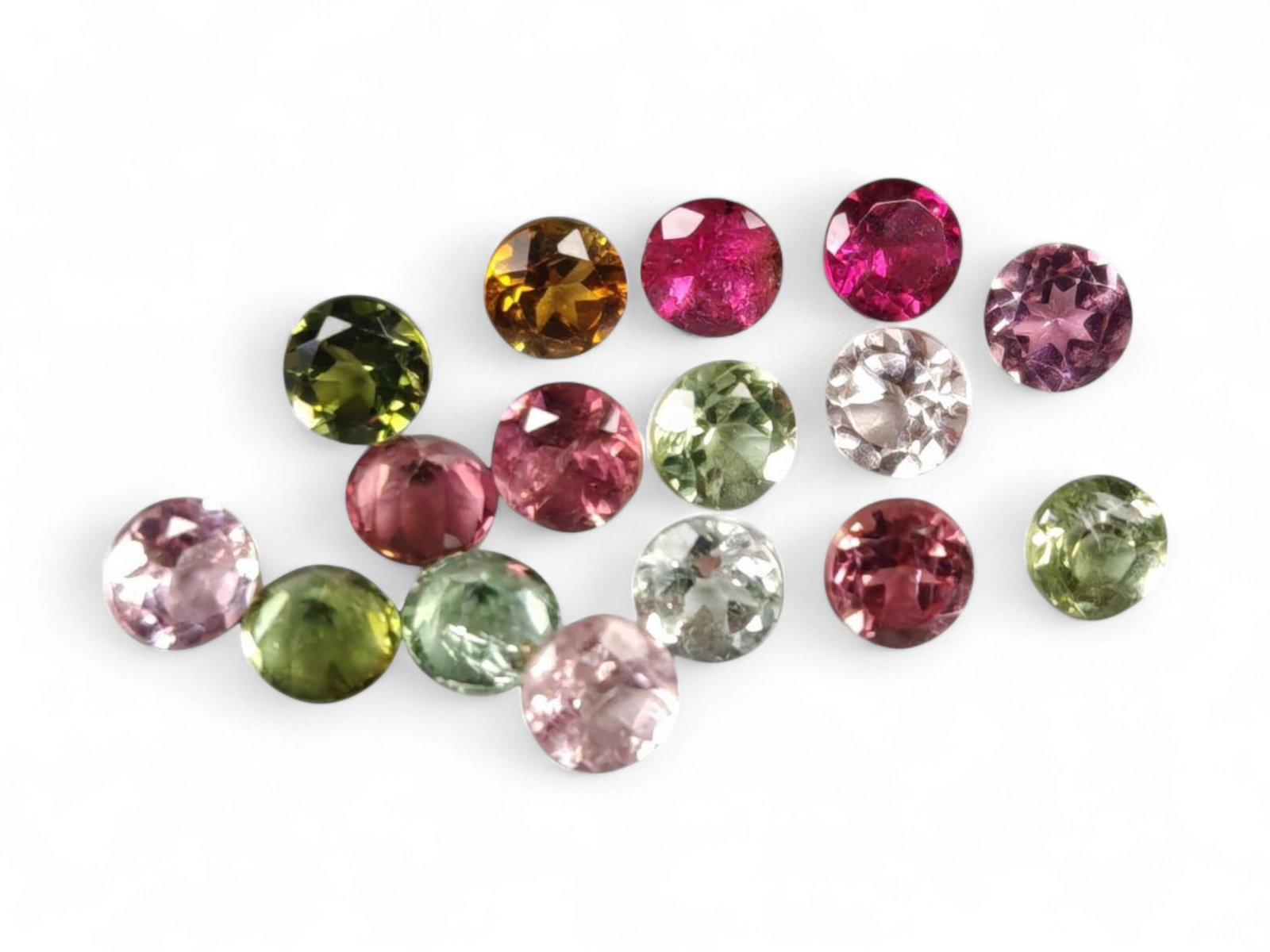 1.94 Carats Multicolor Tourmaline Round Lot - Natural Nigerian Stones: This charming lot of small round-cut tourmalines displays a vibrant spectrum of colors, from soft blush pink and mint green to golden amber, deep olive, and vivid magenta. Each gem measures approximat