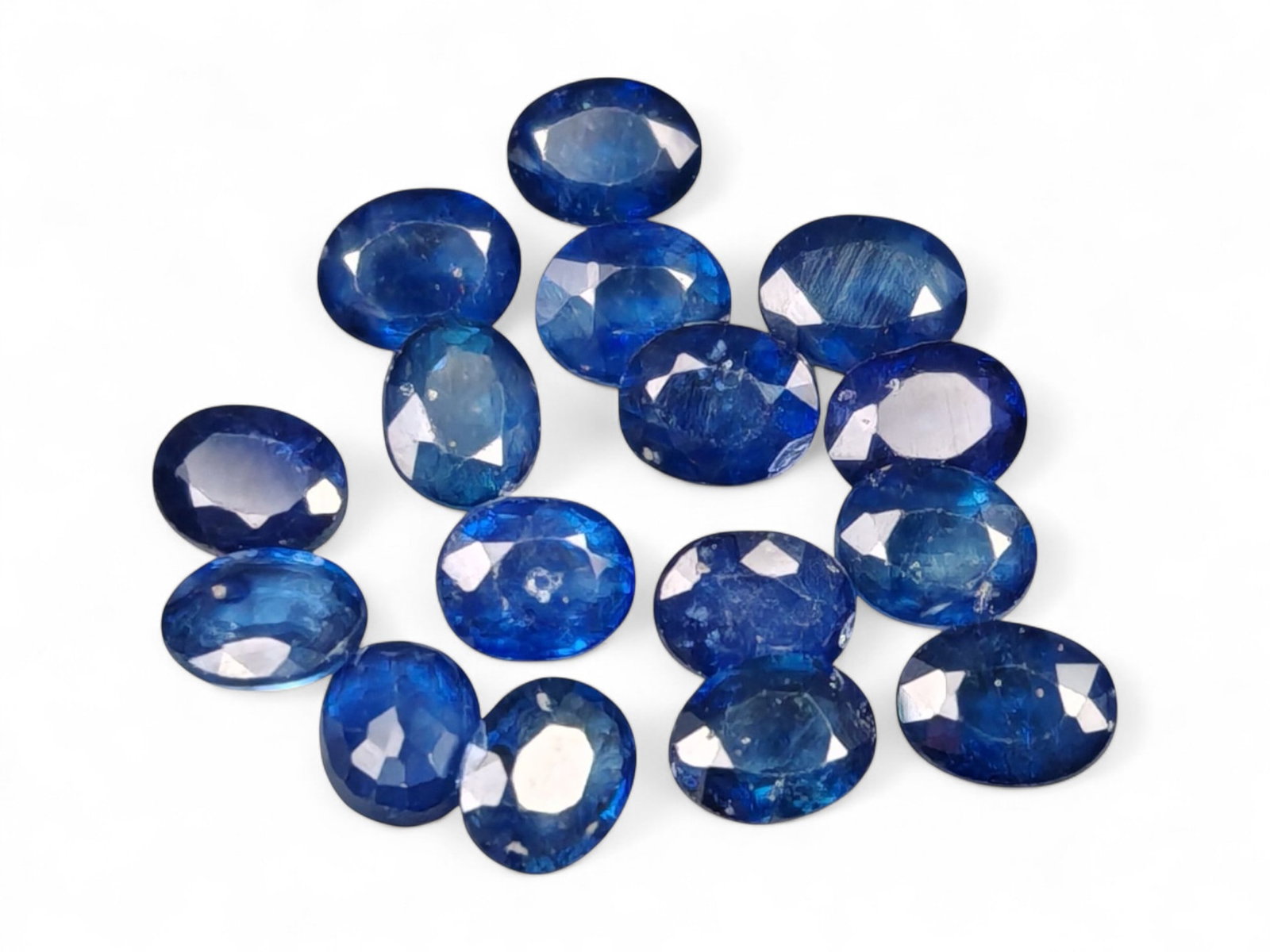 6.41 Carats Royal Blue Sapphire Oval Lot - Natural Ceylon Stones: This captivating lot of oval-cut sapphires exhibits a deep royal blue color, rich and even, with flashes of lighter brilliance across the facets. Each stone, measuring approximately 4.7x3.8x2.2mm, is 