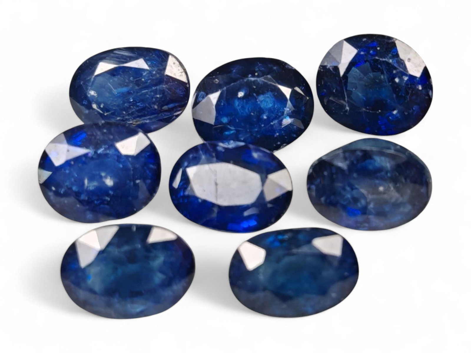 10.53 Carats Royal Blue Sapphire Oval Lot - Natural Ceylon Stones: This captivating lot of oval-cut sapphires exhibits a deep royal blue color, rich and even, with flashes of lighter brilliance across the facets. Each stone, measuring approximately 7x5x3mm, is gracef