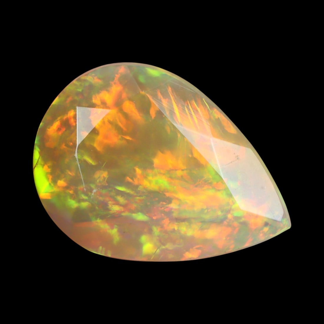 2.37 Carats Pear-Cut Faceted Welo Opal - Natural Ethiopian Stone: This graceful 12.5x9x5.7 mm Ethiopian opal radiates a soft yet vibrant play-of-color, with hues of green, orange, and rose blending harmoniously beneath its faceted pear-shaped surface. The gem displa