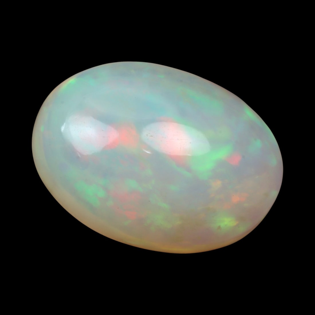 6.50 Carats Light Play-of-Color Opal Cabochon - Natural Ethiopian Stone: This elegant 16 x 11.7 x 7.6 mm Ethiopian opal glows with an ethereal inner fire, displaying soft flashes of green, orange, and pink across a delicate milky-white body tone. Its smooth, domed cabochon