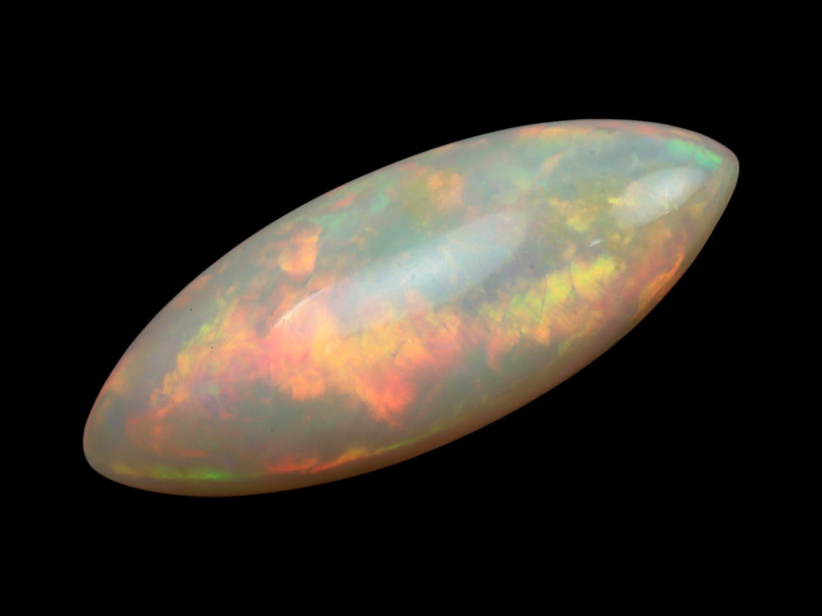 6.70 Carats Light Play-of-Color Opal Cabochon - Natural Ethiopian Stone: This elegant 24.7x9.6x5.9 mm Ethiopian opal glows with an ethereal inner fire, displaying soft flashes of green, orange, and pink across a delicate milky-white body tone. Its smooth, domed cabochon su