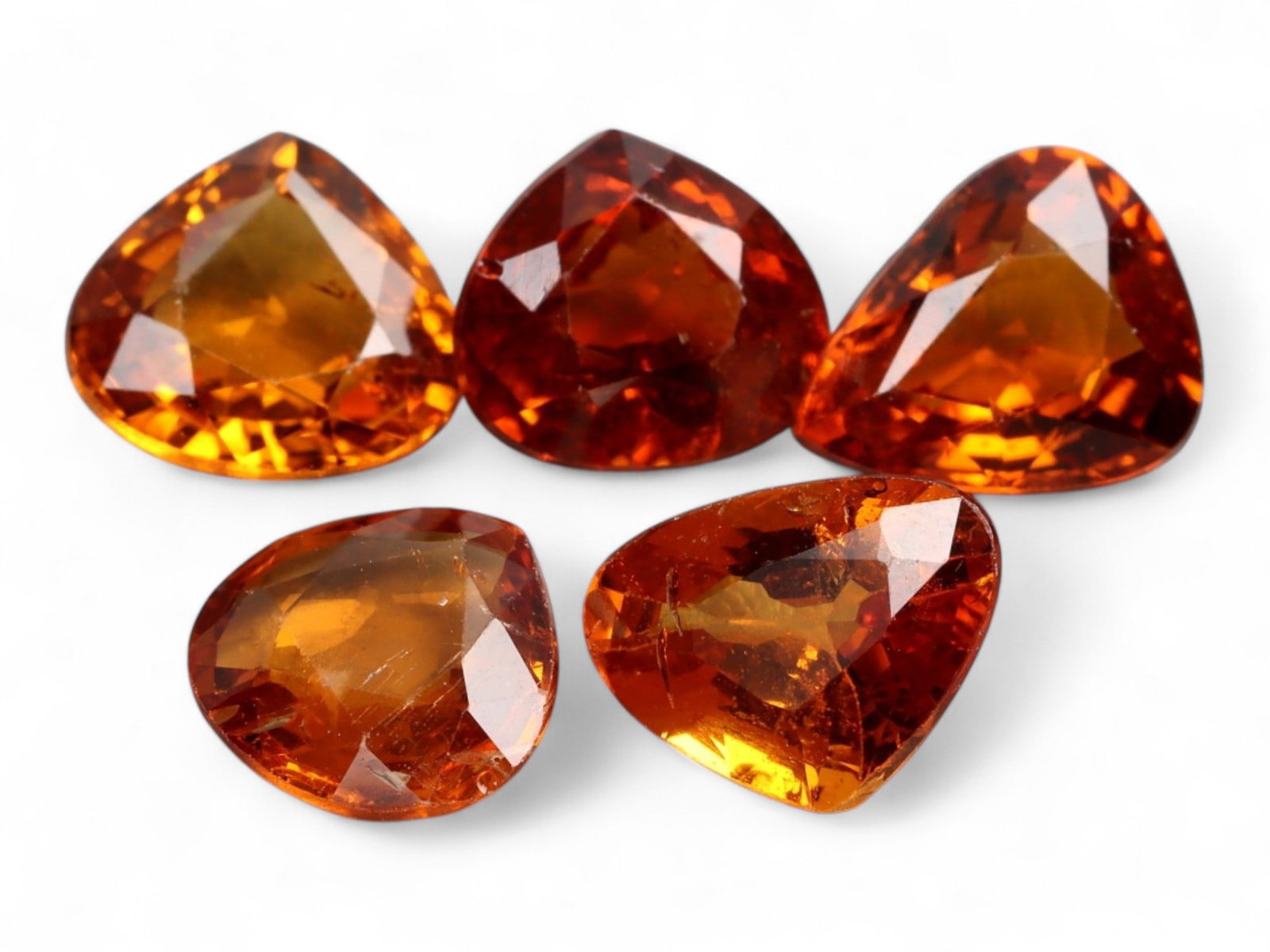 4.95 Carats Golden-Orange Faceted Songea Sapphire Parcel - Natural Tanzanian Stones: This vibrant parcel of Songea sapphires glows with a fiery palette ranging from deep amber and burnt orange to bright golden honey tones. Each gem, averaging 7.1x5.1x3.0 mm, is expertly faceted to max