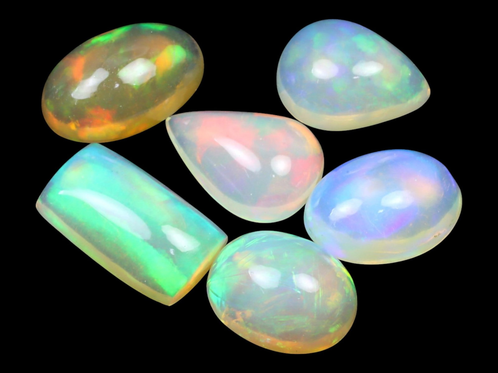 10.74 Carats Multi-Color Welo Opal Lot - Natural Ethiopian Stones: This radiant group of Welo opals displays a mesmerizing interplay of color that dances across the surface with every shift of light. Electric flashes of green, orange, and red ripple through a translu