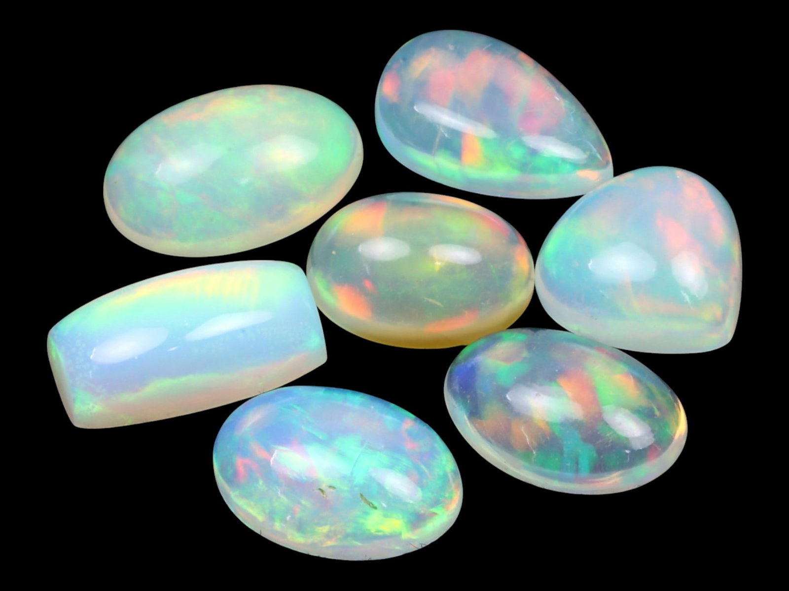 12.27 Carats Multi-Color Welo Opal Lot - Natural Ethiopian Stones: This radiant group of Welo opals displays a mesmerizing interplay of color that dances across the surface with every shift of light. Electric flashes of green, orange, and red ripple through a translu