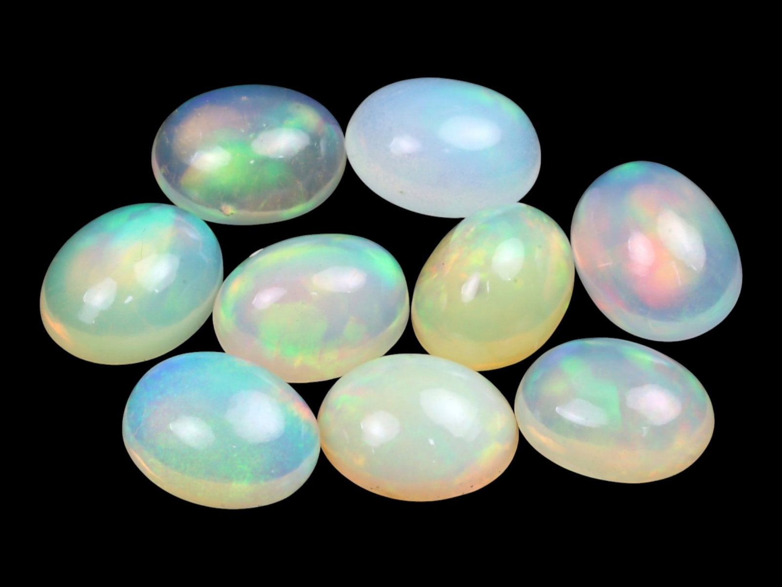 11.22 Carats Multi-Color Welo Opal Lot - Natural Ethiopian Stones: This radiant group of Welo opals displays a mesmerizing interplay of color that dances across the surface with every shift of light. Electric flashes of green, orange, and red ripple through a translu