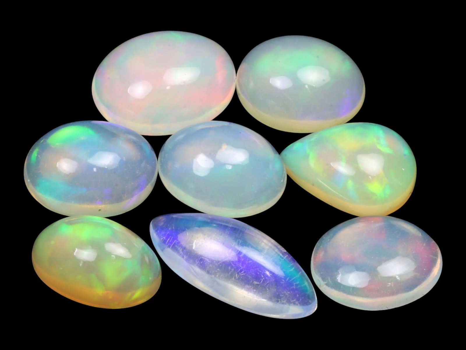 13.65 Carats Multi-Color Welo Opal Lot - Natural Ethiopian Stones: This radiant group of Welo opals displays a mesmerizing interplay of color that dances across the surface with every shift of light. Electric flashes of green, orange, and red ripple through a translu