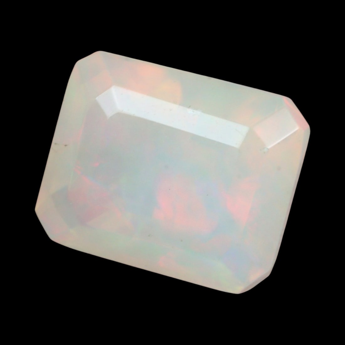2.24 Carats Faceted Welo Opal - Natural Ethiopian Stone: This graceful 9.3x7.7x6.2 mm Ethiopian opal radiates a soft yet vibrant play-of-color, with hues of green, orange, and rose blending harmoniously beneath its faceted surface. The gem displays a fluid 