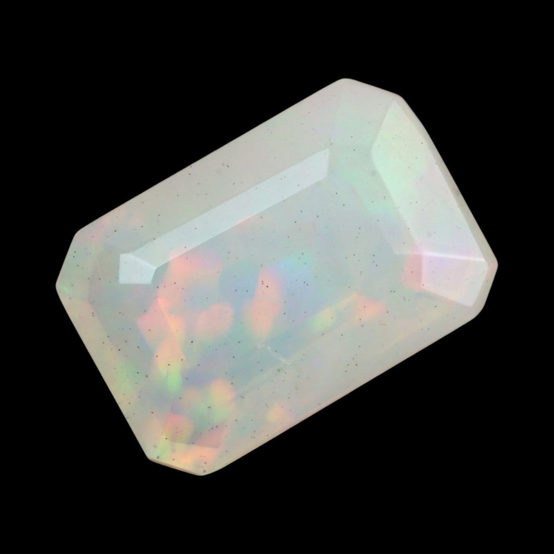 1.83 Carats Faceted Welo Opal - Natural Ethiopian Stone: This graceful 10.5x7.2x4.6 mm Ethiopian opal radiates a soft yet vibrant play-of-color, with hues of green, orange, and rose blending harmoniously beneath its faceted surface. The gem displays a fluid