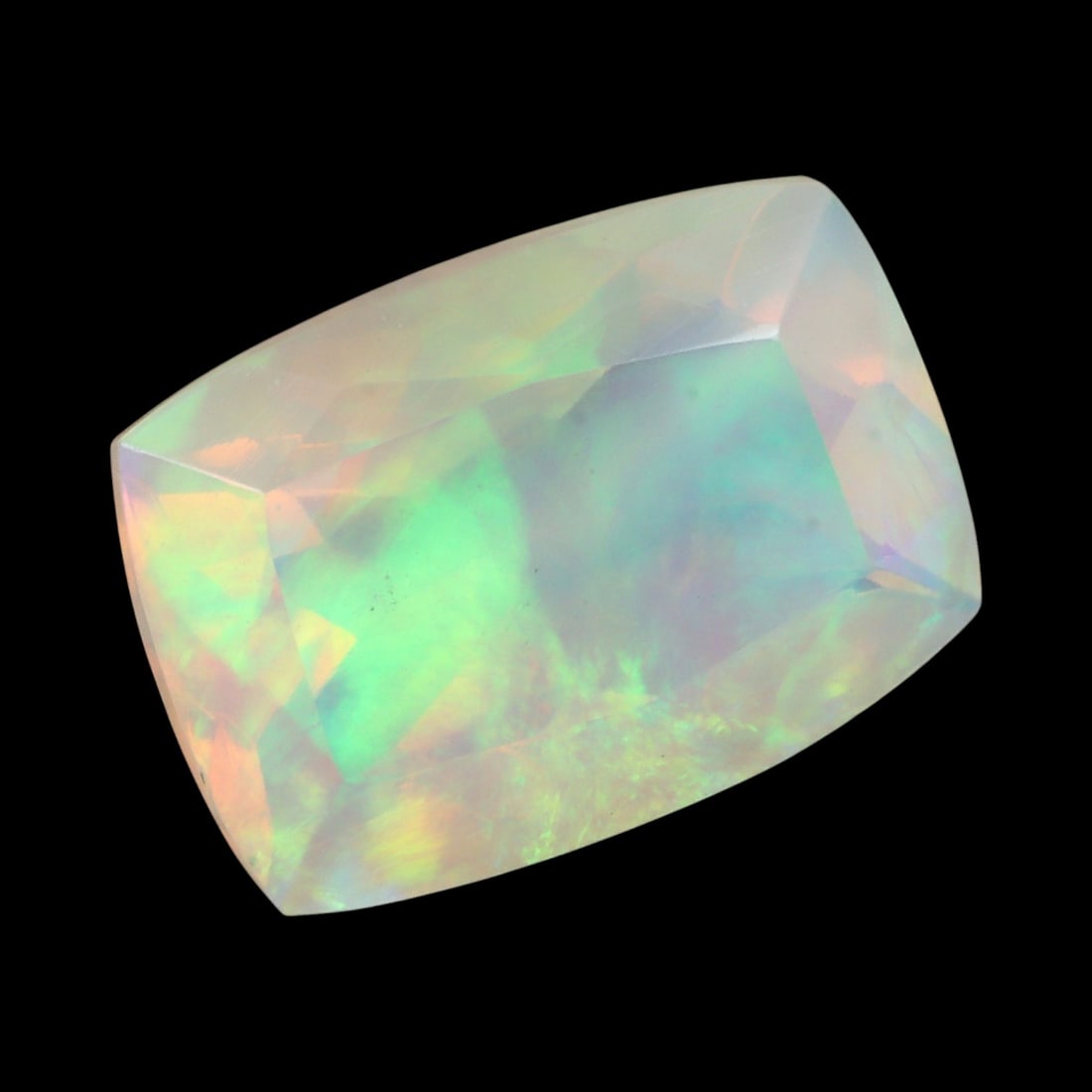 2.28 Carats Faceted Welo Opal - Natural Ethiopian Stone: This graceful 10.5x7.5x5.8 mm Ethiopian opal radiates a soft yet vibrant play-of-color, with hues of green, orange, and rose blending harmoniously beneath its faceted surface. The gem displays a fluid