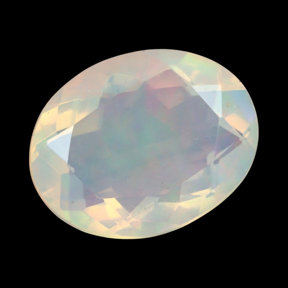 1.76 Carats Faceted Welo Opal - Natural Ethiopian Stone: This graceful 10x7.9x5.0 mm Ethiopian opal radiates a soft yet vibrant play-of-color, with hues of green, orange, and rose blending harmoniously beneath its faceted surface. The gem displays a fluid m