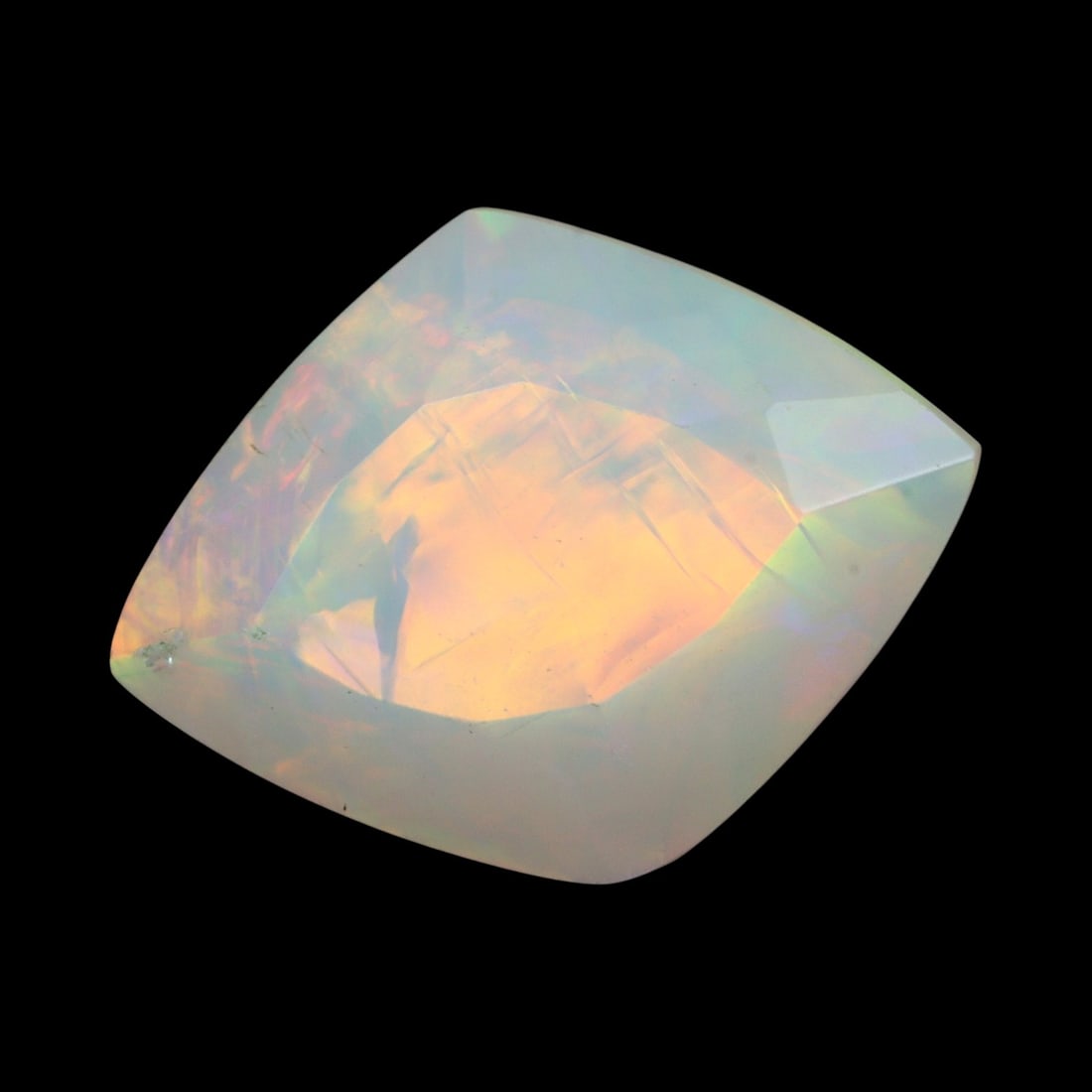 3.03 Carats Faceted Welo Opal - Natural Ethiopian Stone: This graceful 13.8x10.4x7.2 mm Ethiopian opal radiates a soft yet vibrant play-of-color, with hues of green, orange, and rose blending harmoniously beneath its faceted surface. The gem displays a flui