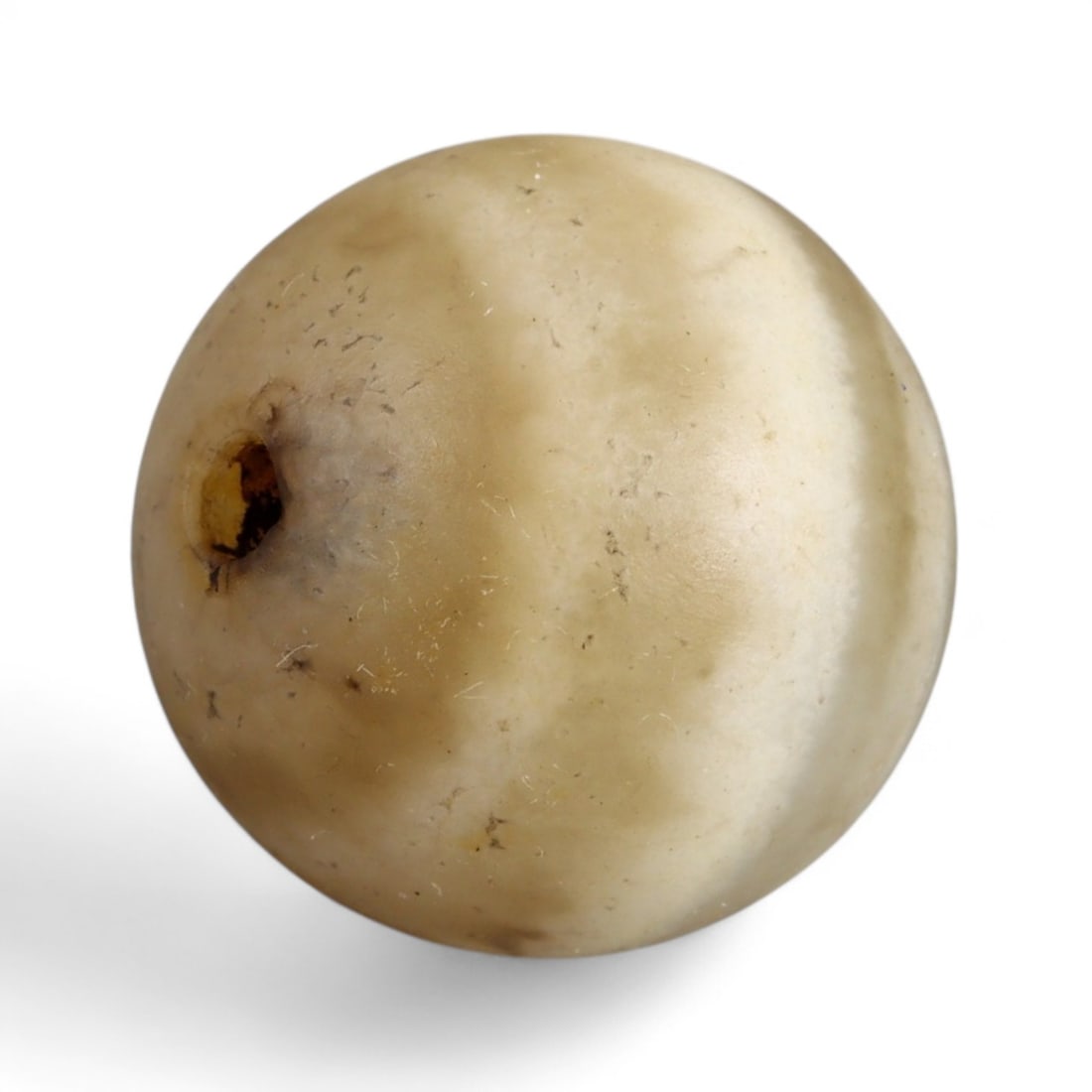 Ancient Himalayan Eye Agate Dzi Bead, c. 3rd-7th Century CE, 1.5cm: This remarkable spherical bead, measuring 2 cm, belongs to the class of ancient Dzi beads that have long been revered in Tibet and the wider Himalayan world. Its defining feature is the concentric "ey