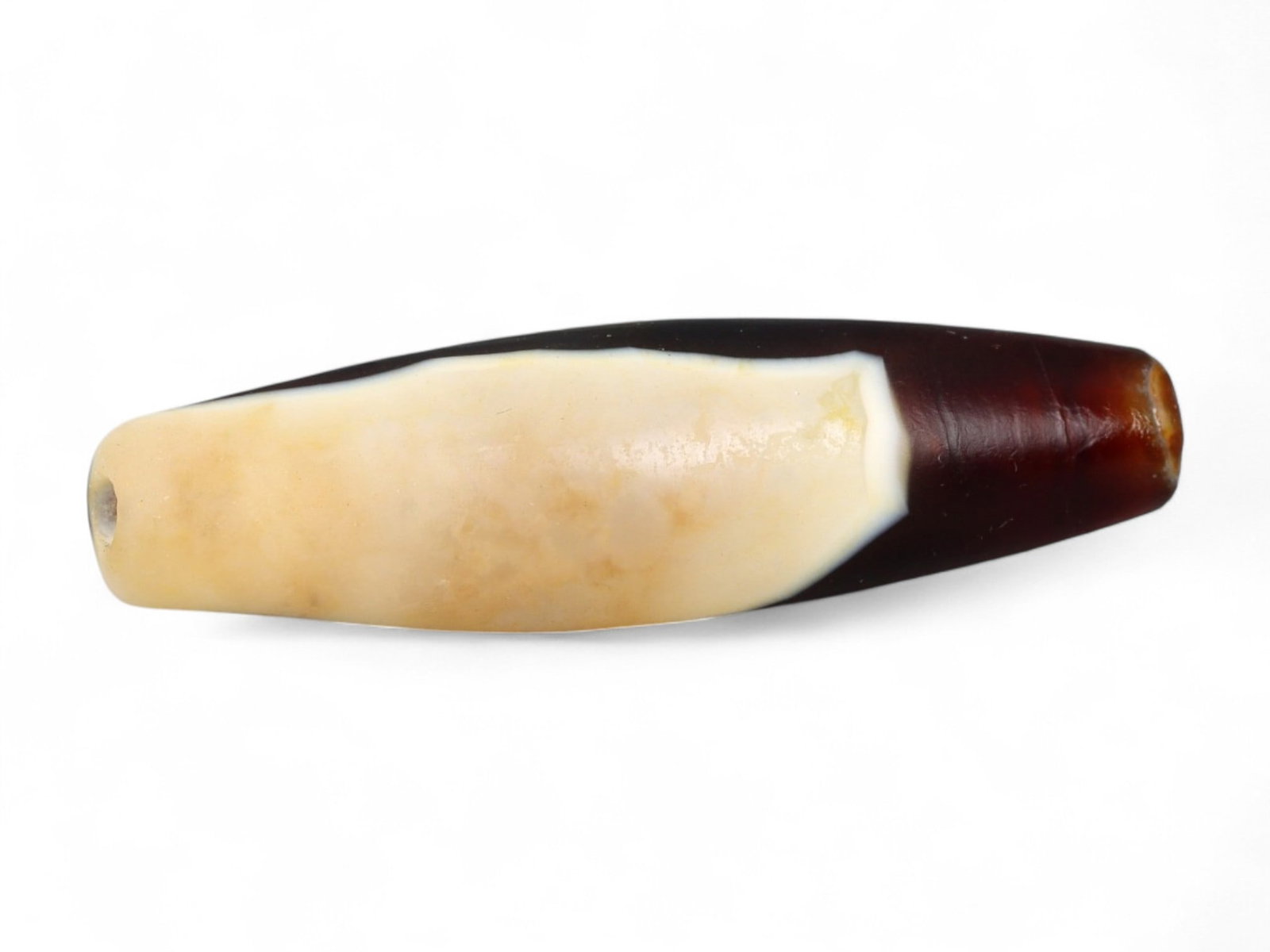 Ancient Tibetan Himalayan Banded Agate Dzi Bead, c. 9th-14th Century CE, 4.5cm: This ancient Tibetan Dzi bead, measuring 2.6 cm, is carved from richly banded agate, its surface revealing bold layers of deep red, amber, and ivory-white. Its elongated cylindrical form, tapering at 