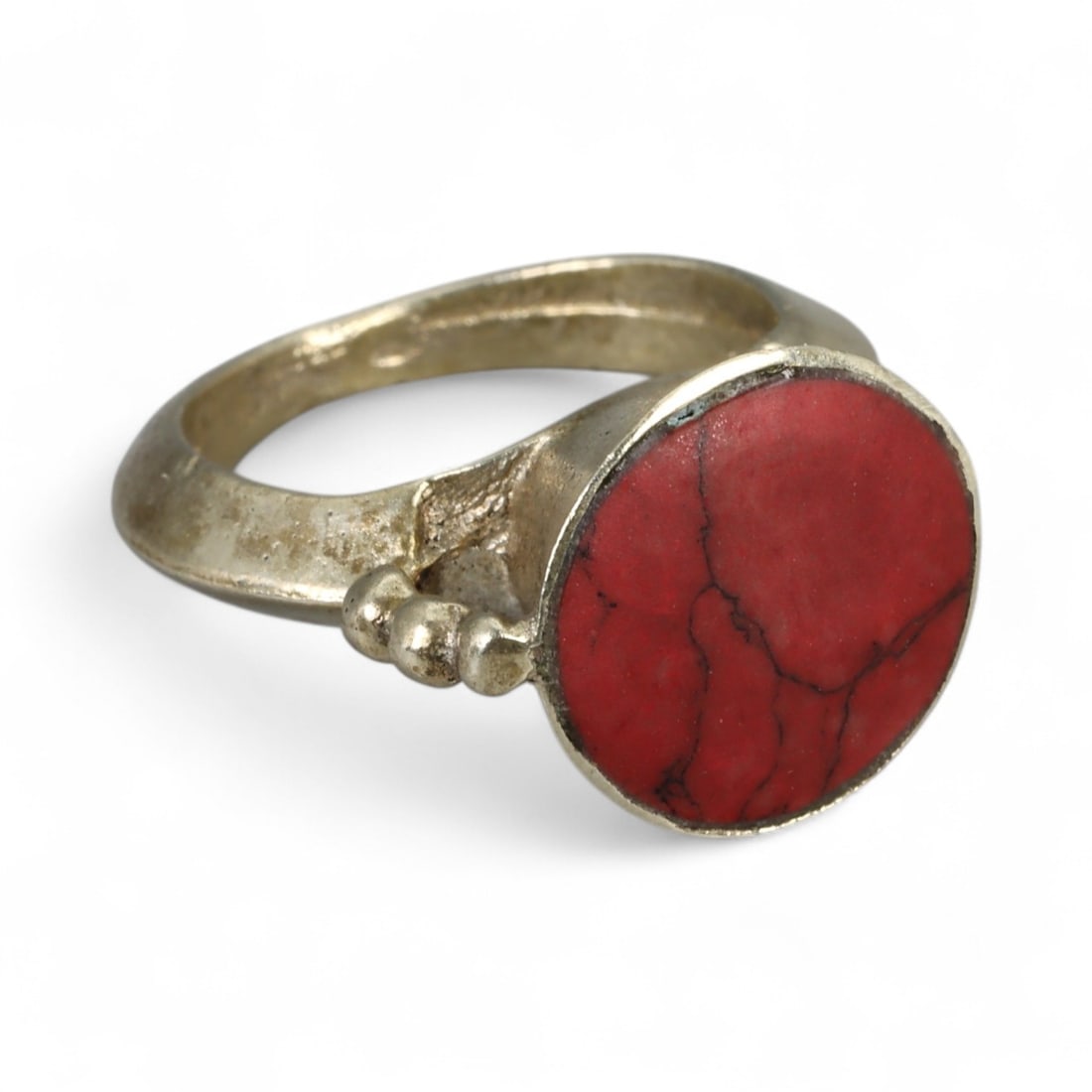 Antique Central Asian Red Stone Bezel Silver Ring, c. 19th-20th Century 5g: This antique silver ring, dating to the 19th-20th century, embodies the understated yet powerful elegance of Central Asian craftsmanship. Its defining feature is the striking circular bezel set with a