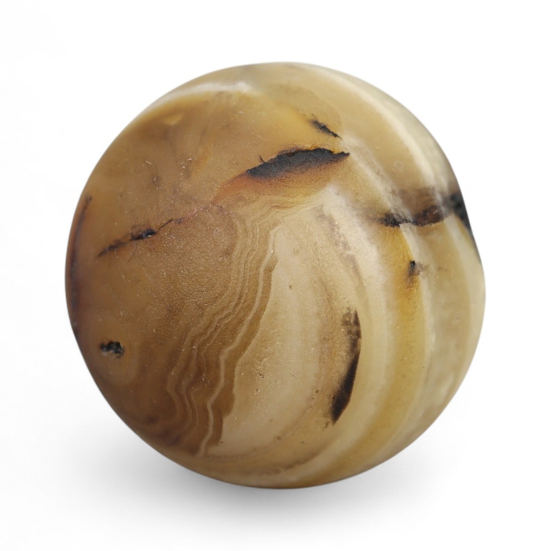 Ancient Himalayan Eye Agate Dzi Bead, c. 3rd-7th Century CE, 2cm: This remarkable spherical bead, measuring 2 cm, belongs to the class of ancient Dzi beads that have long been revered in Tibet and the wider Himalayan world. Its defining feature is the concentric "ey