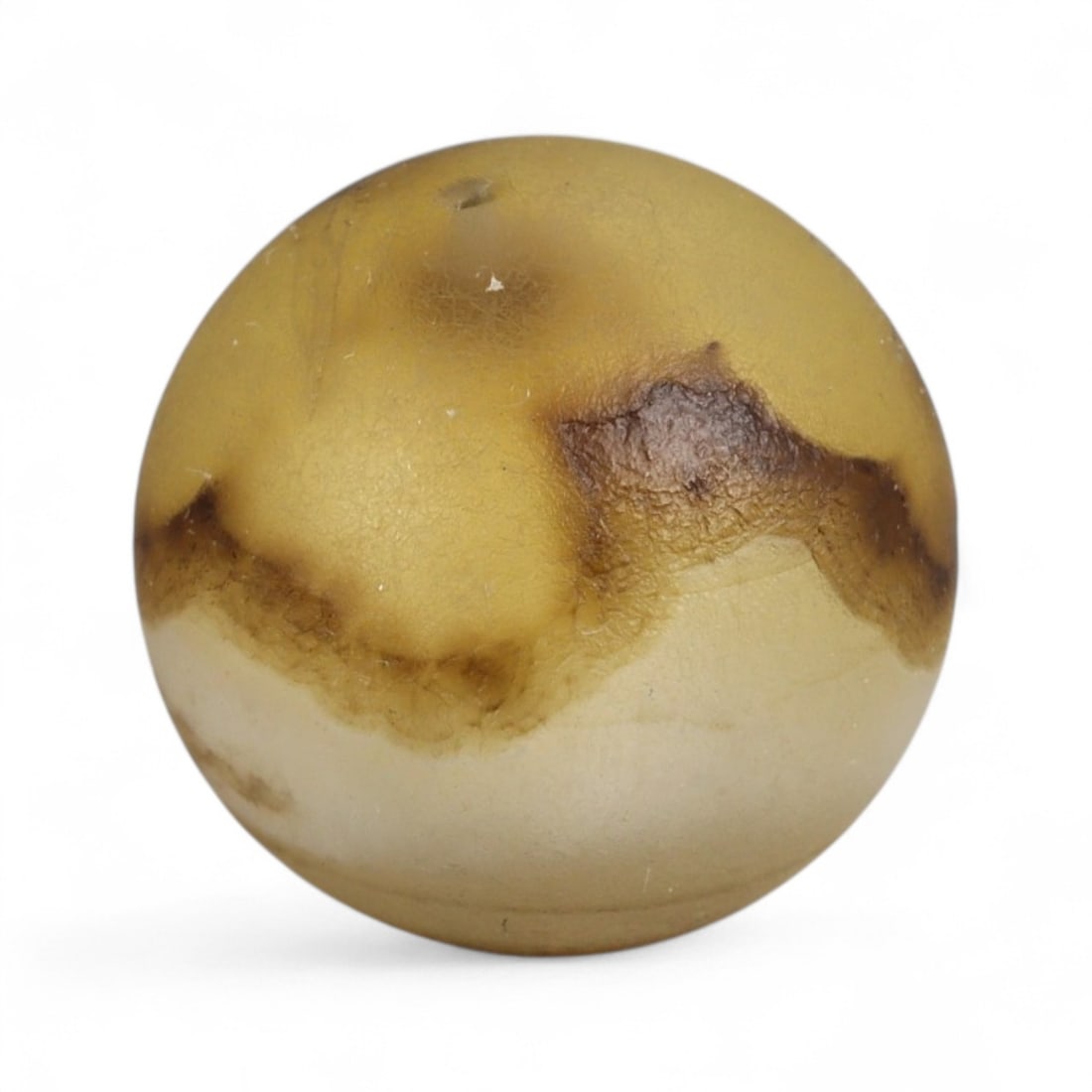 Ancient Himalayan Eye Agate Dzi Bead, c. 3rd-7th Century CE, 1.3cm: This remarkable spherical bead, measuring 2 cm, belongs to the class of ancient Dzi beads that have long been revered in Tibet and the wider Himalayan world. Its defining feature is the concentric "ey