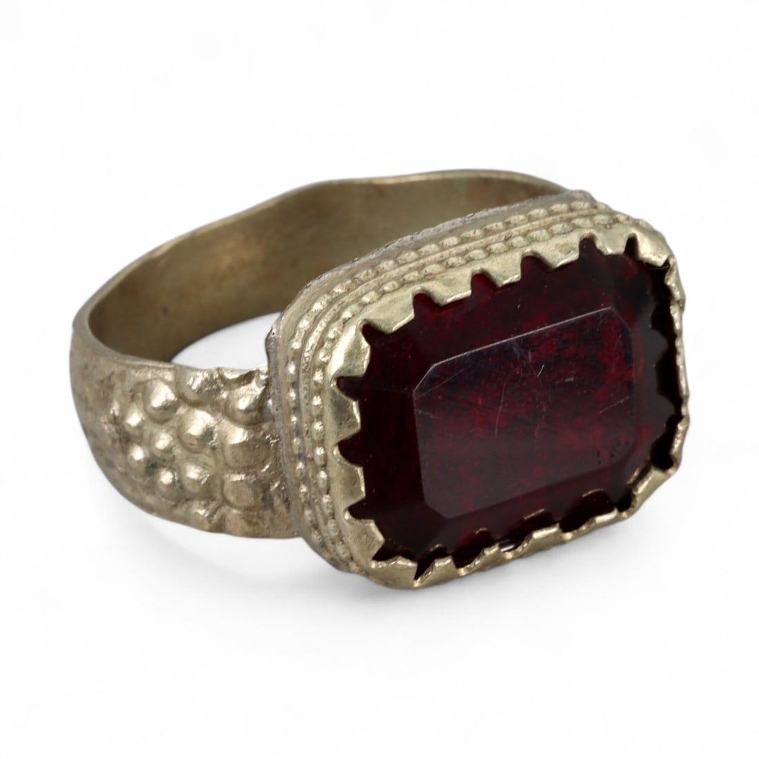 Antique Central Asian Silver Ring with Rectangular Red Glass, c. 19th-20th Century, 6.5g: This antique silver ring from Central Asia reflects the bold, geometric jewelry traditions of the 19th to early 20th century. Its rectangular bezel holds a deep red glass stone, faceted to catch the l