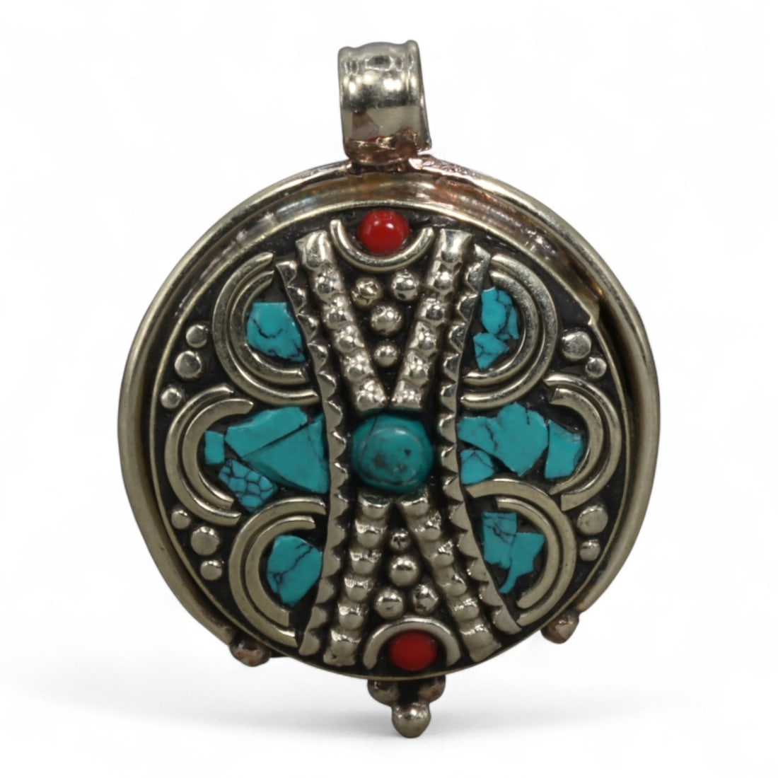 Vintage Tibetan Silver and Turquoise Pendant, c. Mid-20th Century, 3.5cm: This vintage Tibetan pendant, dating to the mid-20th century, features a bold circular silver setting inlaid with natural turquoise cabochons and fragments. the pendant is decorated with raised granul