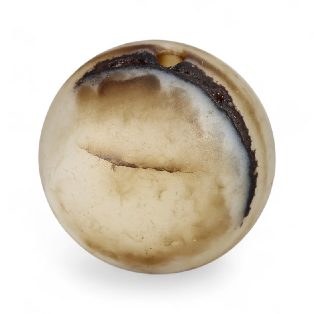 Ancient Himalayan Banded Agate Spherical Dzi Bead, c. 3rd-7th Century CE, 2cm: This elegant spherical bead, carved from natural agate and measuring 2 cm, exemplifies the refined simplicity of Himalayan Dzi tradition. Its smooth, rounded form reveals delicate layers of cream, smo