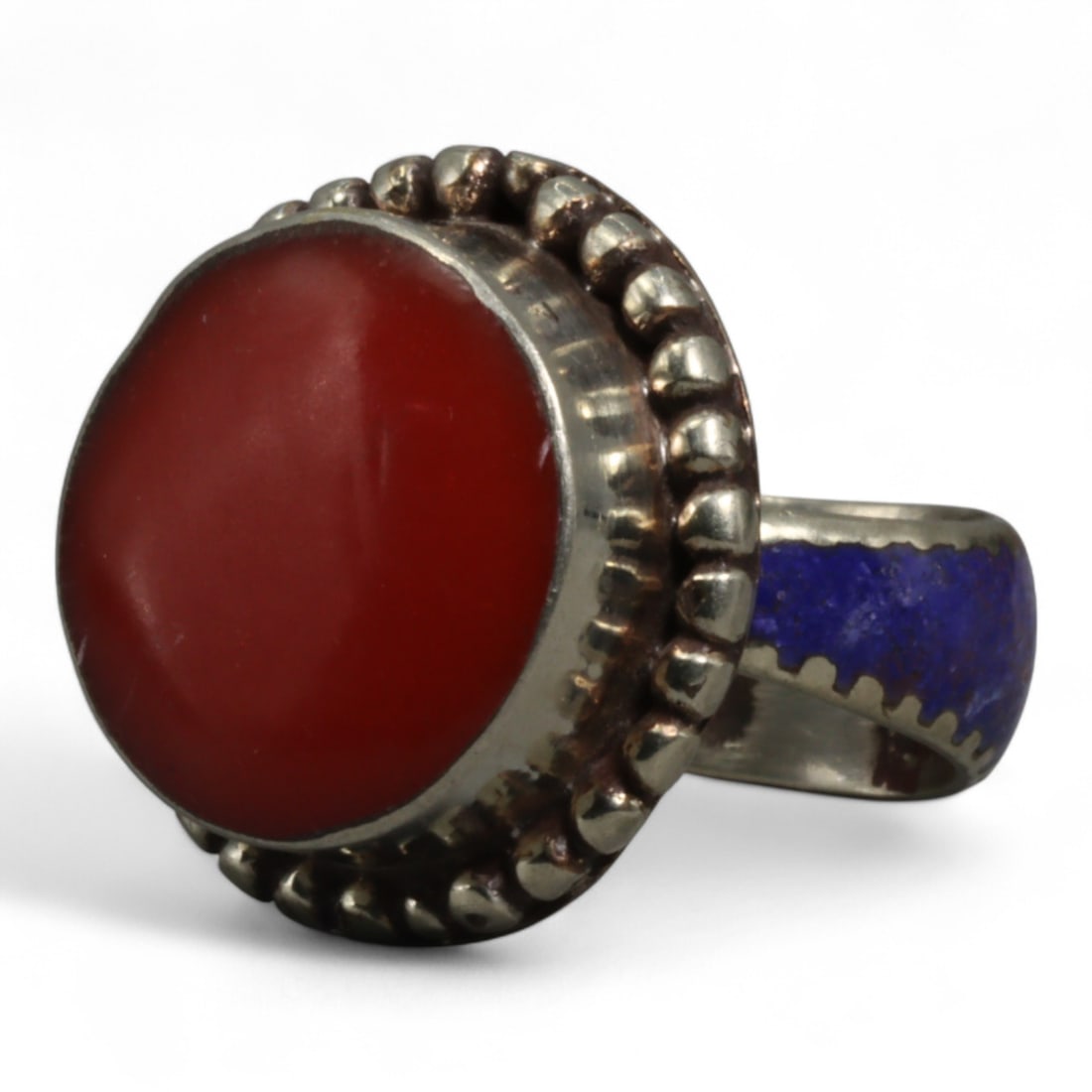 Vintage Himalayan Red Carnelian Lapis Silver Ring, Mid-20th Century, US 9: This vintage ring, crafted in the mid-20th century, captures the striking contrast and symbolic power of Himalayan jewelry design. Sized at US 9, the piece centers on a bold, polished red carnelian ca