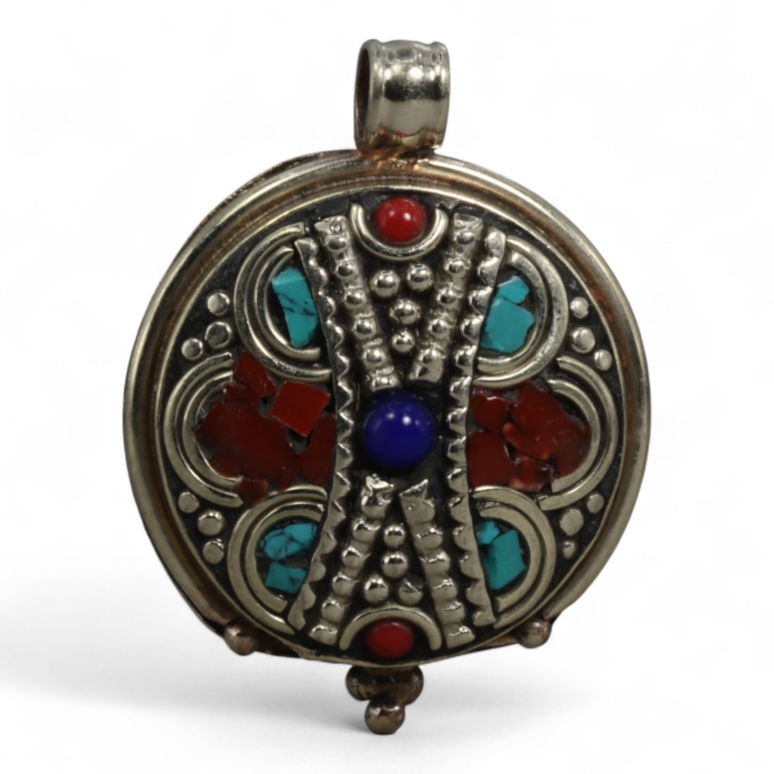 Vintage Tibetan Silver and Turquoise Pendant, c. Mid-20th Century, 3.5cm: This vintage Tibetan pendant, dating to the mid-20th century, features a bold circular silver setting inlaid with natural turquoise cabochons and fragments. the pendant is decorated with raised granul