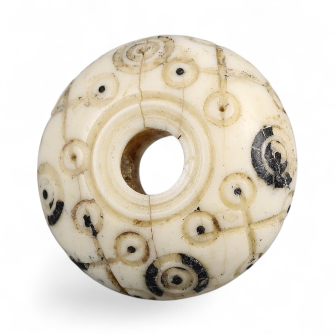 Ancient Medieval Nishapur Silk Road Bone Spindle Whorl, c. 9th-11th Century CE, 1.8cm: This finely carved spindle whorl originates from Nishapur, an important Silk Road city in medieval northeastern Iran, dating to approximately the 9th-11th century CE. Such spindle whorls were essentia