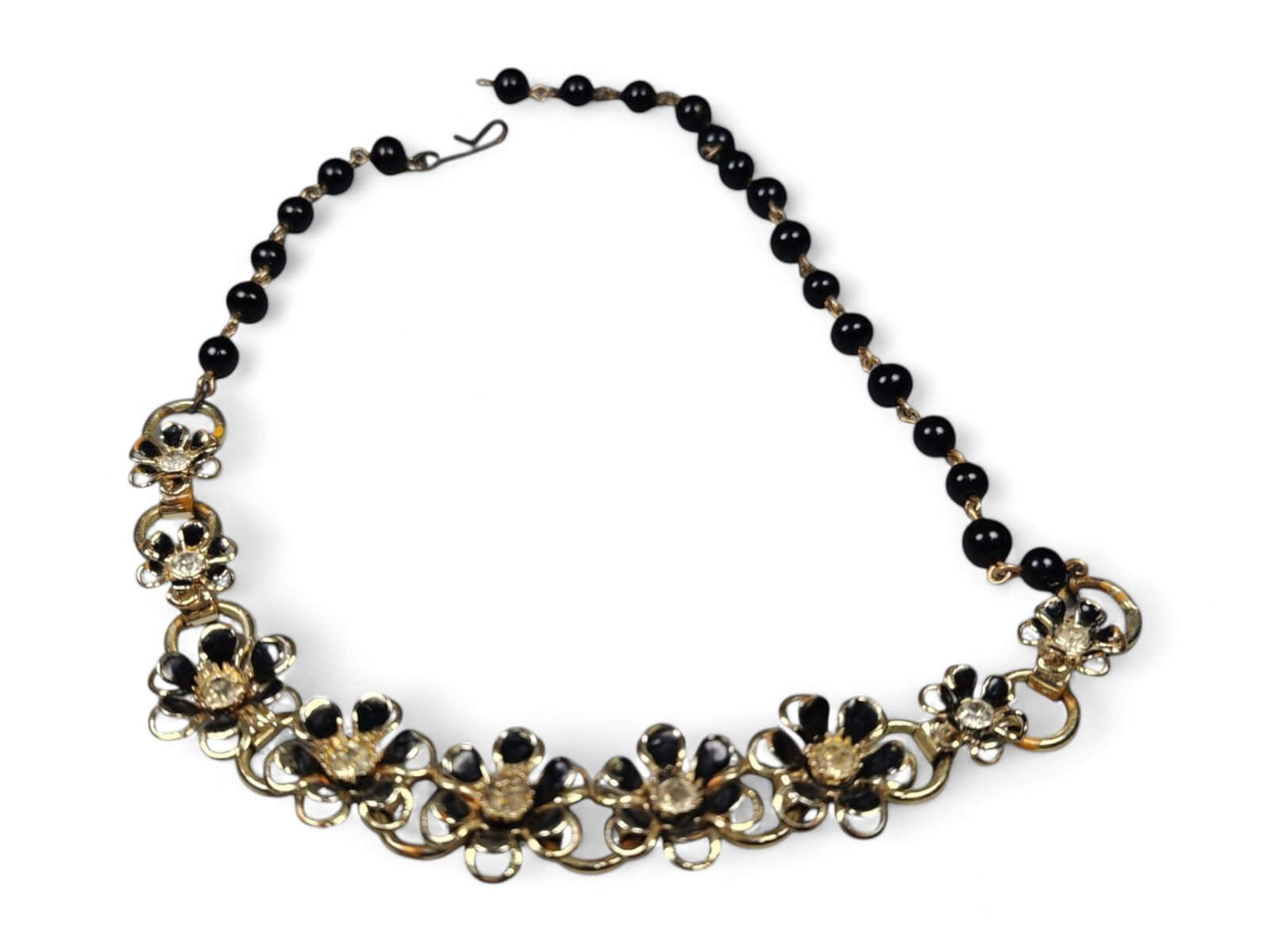18cm Black and Gold Floral Necklace - Enamel and Beaded Design: This refined 18 cm statement necklace combines the elegance of black enamel with the warmth of gold-tone metalwork, forming a striking floral motif. The design showcases alternating open-petal flowers