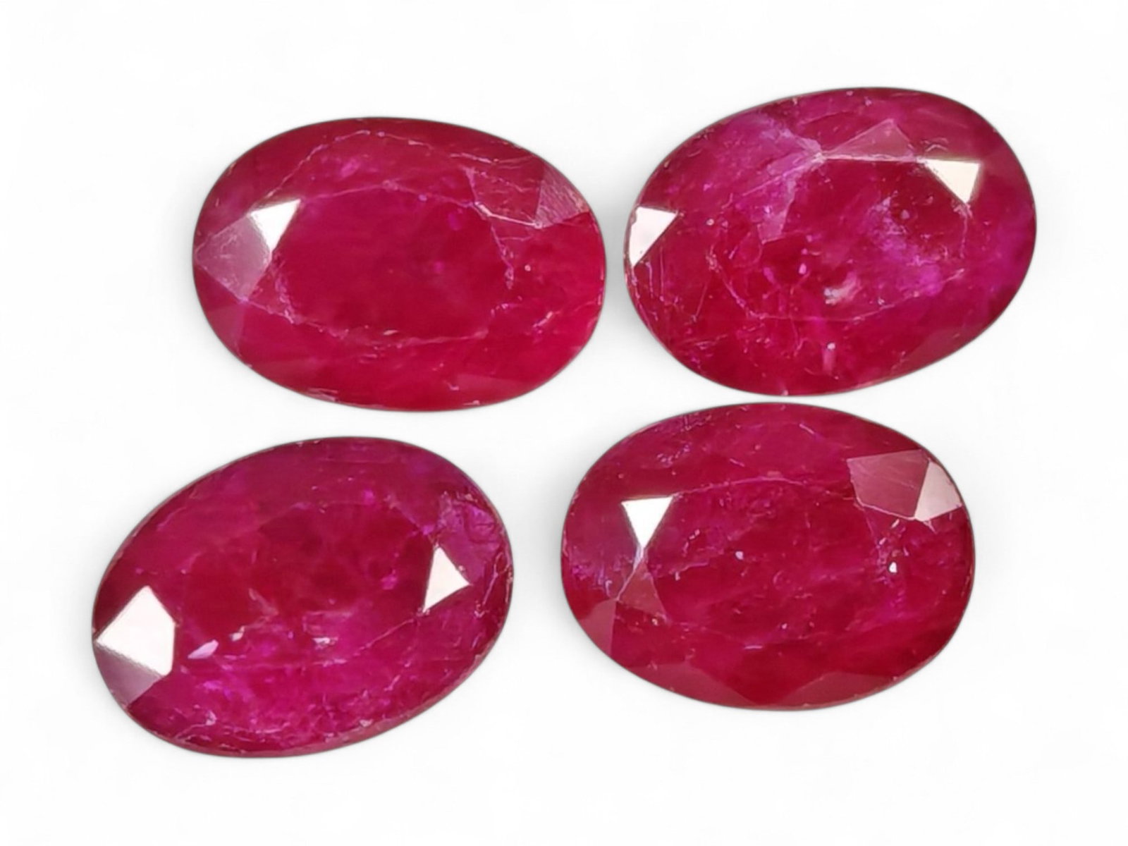 3.62 Carats Vivid Red Ruby Oval Lot - Natural Mozambique Stones: This striking lot of ruby ovals gleams with an intense, saturated red hue infused with a touch of magenta, exuding the classic vibrancy that defines fine ruby. Each gem, measuring approximately 7x4.9x