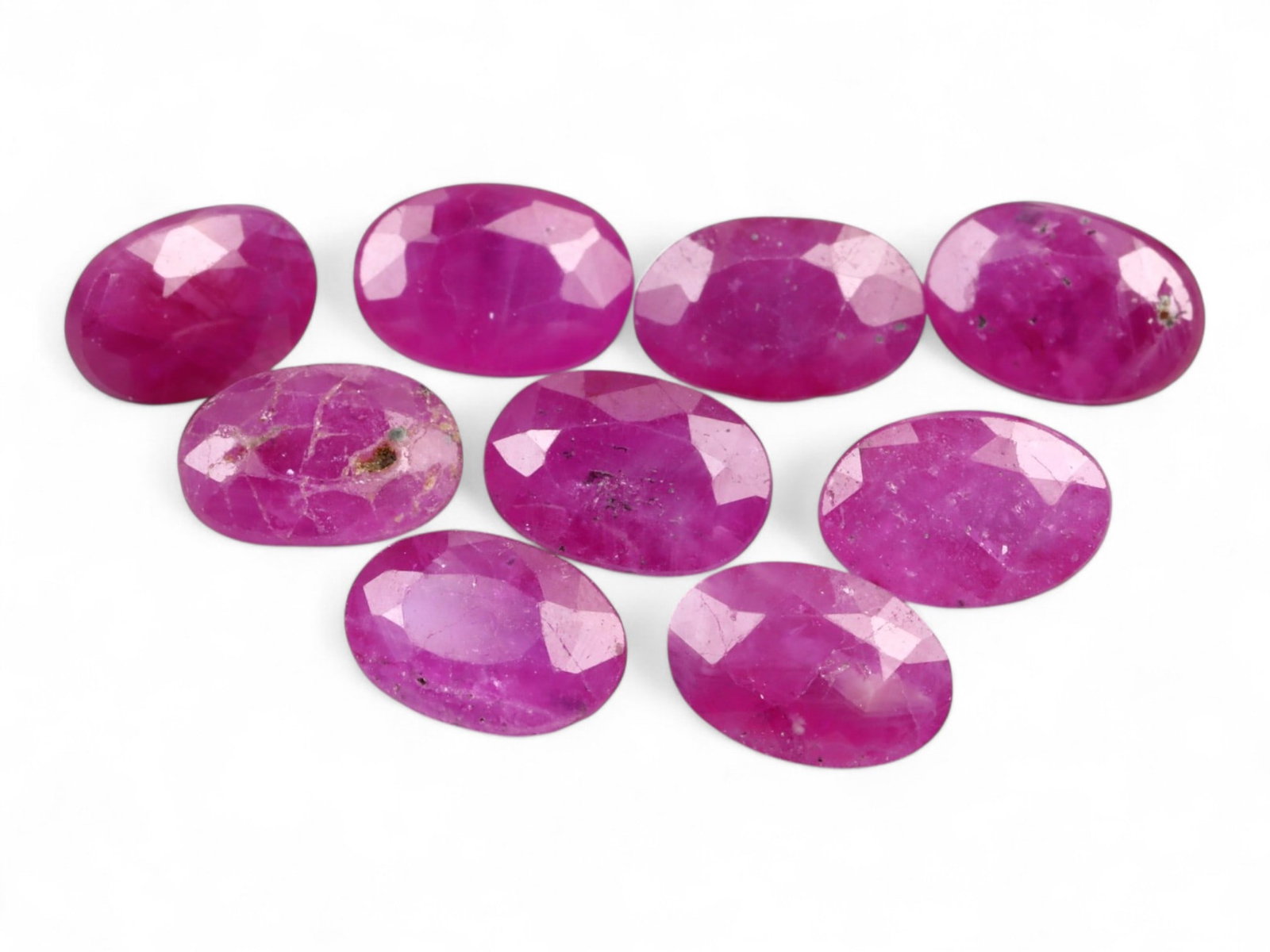 5.87 Carats Vivid Pinkish Red Ruby Oval Lot - Natural Mozambique Stones: This lively lot of ruby ovals glows with an intense pinkish-red tone that captures the eye with warmth and vibrancy. Each gem, measuring approximately 5.6x3.9x2.1mm, reveals a balance of medium to dee