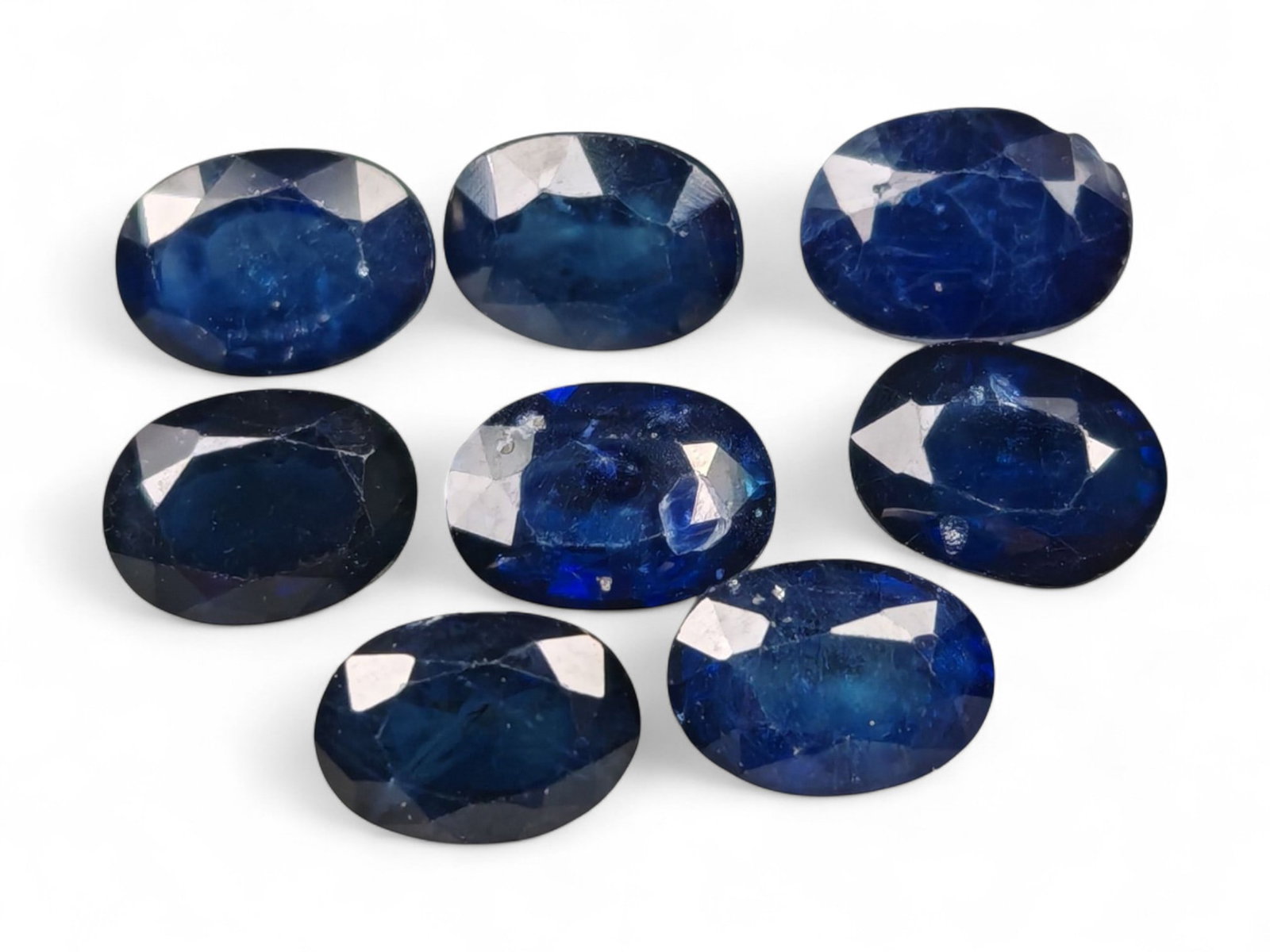 8.49 Carats Royal Blue Sapphire Oval Lot - Natural Ceylon Stones: This captivating lot of oval-cut sapphires exhibits a deep royal blue color, rich and even, with flashes of lighter brilliance across the facets. Each stone, measuring approximately 6x4x3mm, is gracef
