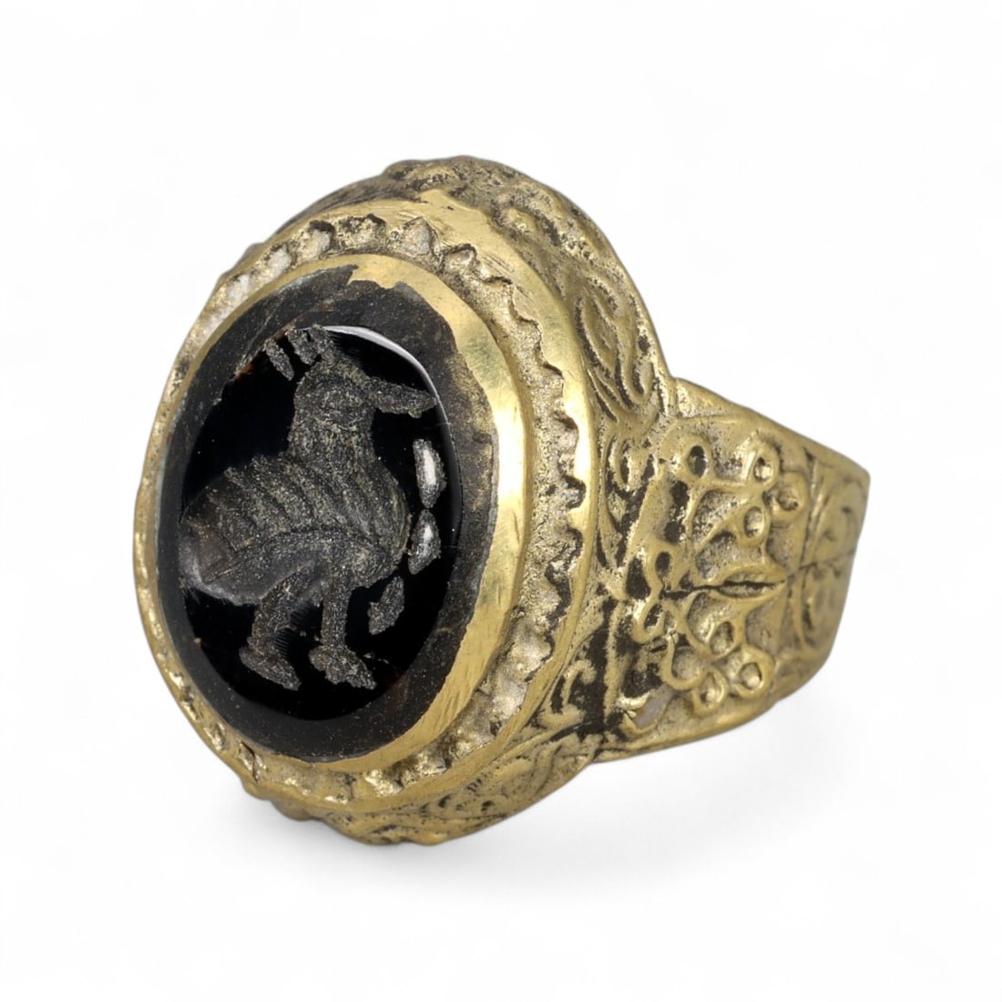 Antique Qajar Gold Gilt Intaglio Signet Ring, c. 19th-20th Century, 7.5 US: This substantial gilt ring, dating to the Qajar era of the 19th-20th century, embodies the regal aesthetic and cultural refinement of Persian jewelry traditions. The bezel is set with an engraved inta