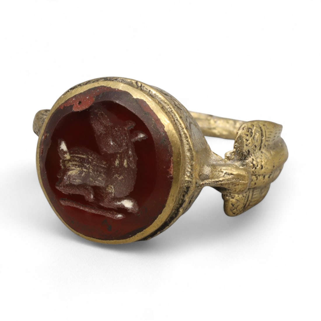 Antique Qajar Gold Gilt Intaglio Signet Ring, c. 19th-20th Century, 7.5 US: This substantial gilt ring, dating to the Qajar era of the 19th-20th century, embodies the regal aesthetic and cultural refinement of Persian jewelry traditions. The bezel is set with an engraved inta