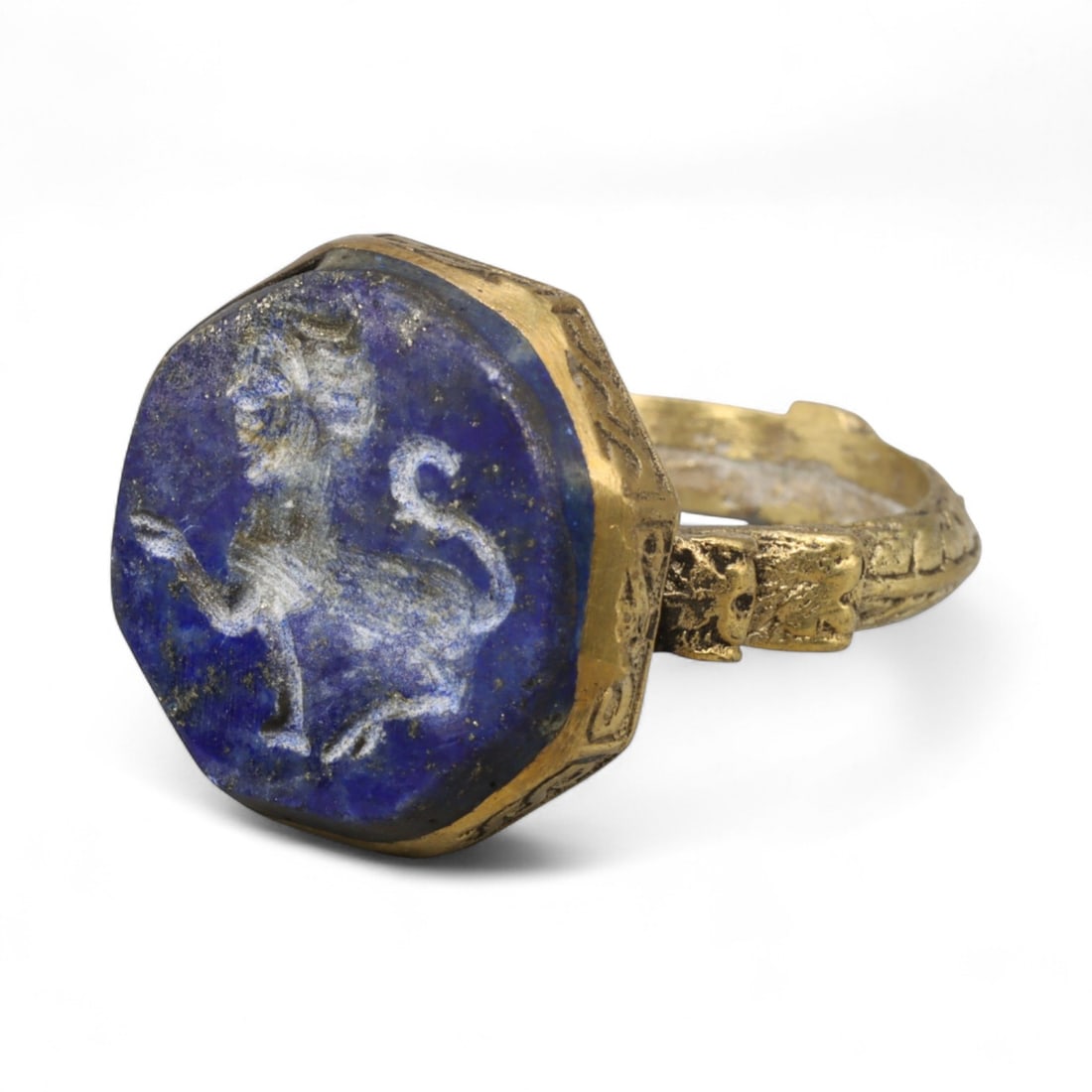 Antique Qajar Gold Gilt Intaglio Signet Ring, c. 19th-20th Century, 8 US: This substantial gilt ring, dating to the Qajar era of the 19th-20th century, embodies the regal aesthetic and cultural refinement of Persian jewelry traditions. The bezel is set with an engraved inta
