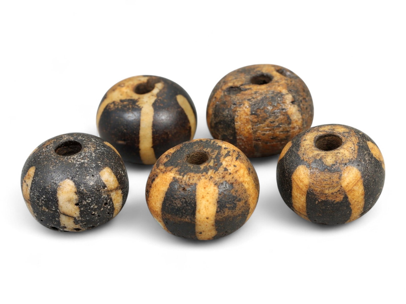 Antique Pyu Pumtek Fossilized Palmwood Vertical Stripe Beads, c. 18th-19th Century CE, 1.2-1.3cm: This lot of antique Pumtek beads, carved from fossilized palm wood, originates from the Pyu bead-making tradition of Burma (modern Myanmar). Dating to the 18th-19th century CE, each bead features etch