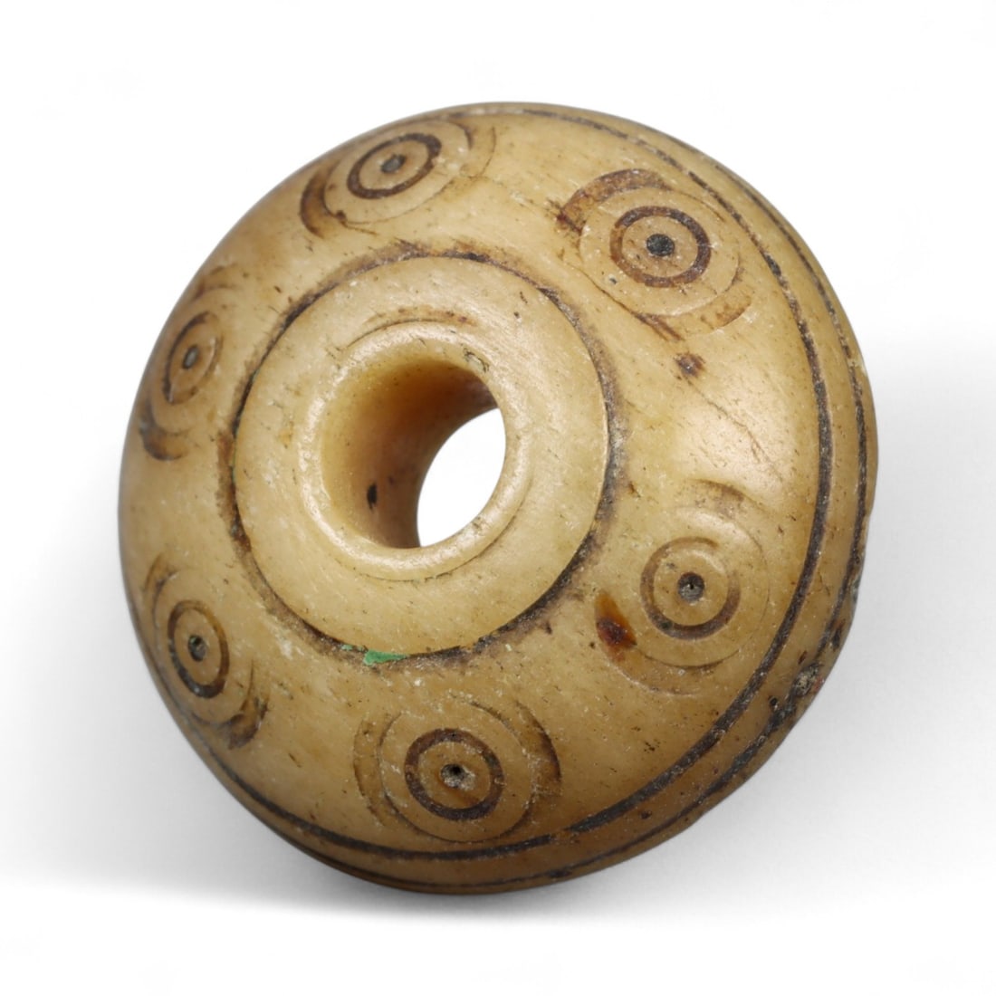Ancient Medieval Nishapur Silk Road Bone Spindle Whorl, c. 9th-11th Century CE, 2cm: This finely carved spindle whorl originates from Nishapur, an important Silk Road city in medieval northeastern Iran, dating to approximately the 9th-11th century CE. Such spindle whorls were essentia